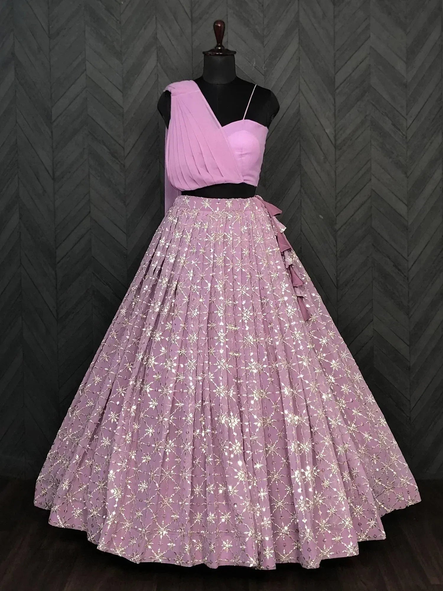 Pink designer lehenga choli with sequin work, pleated skirt, and draped top for Indian ethnic wear