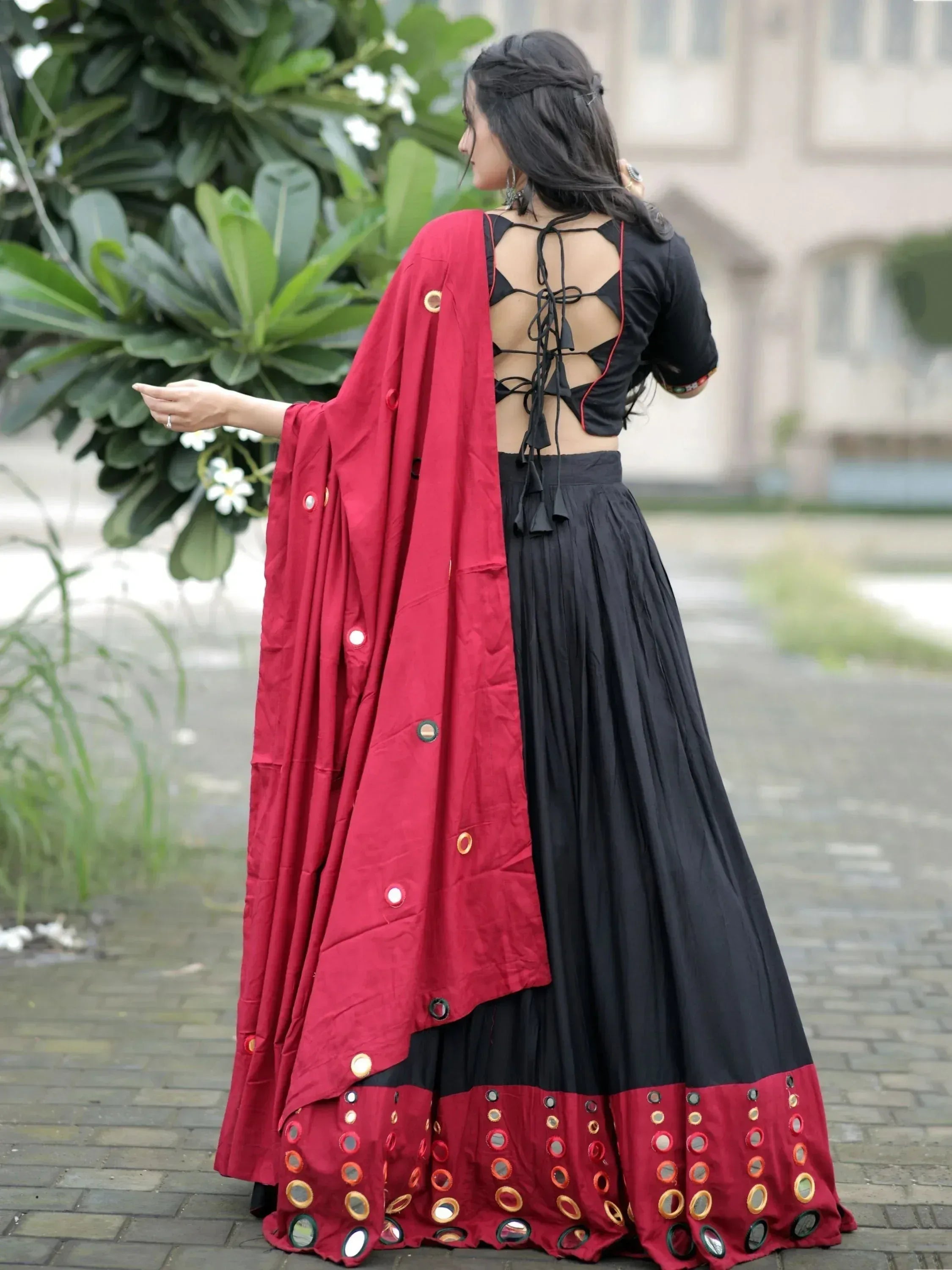 Black and red ethnic lehenga choli with mirror work and open back blouse, perfect for festive occasions
