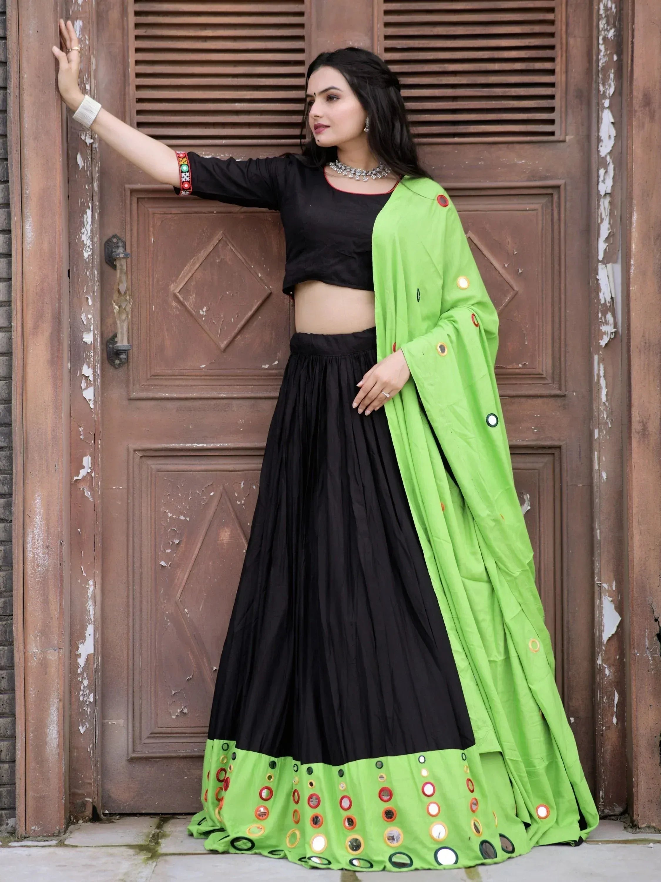 Black and neon green ethnic lehenga choli with mirror work, perfect for Indian festive wear