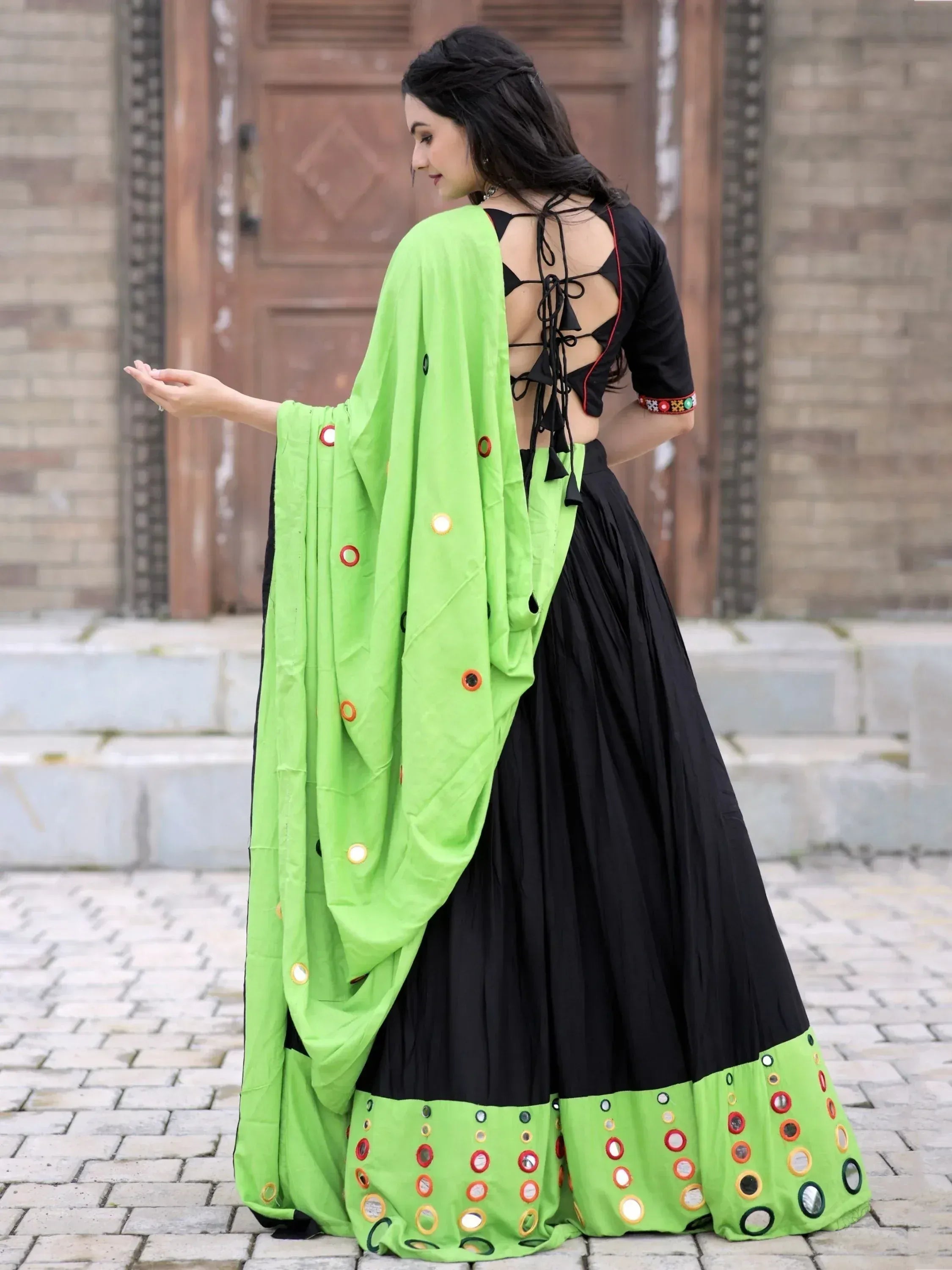 Black and neon green ethnic lehenga choli with mirror work and back tie blouse