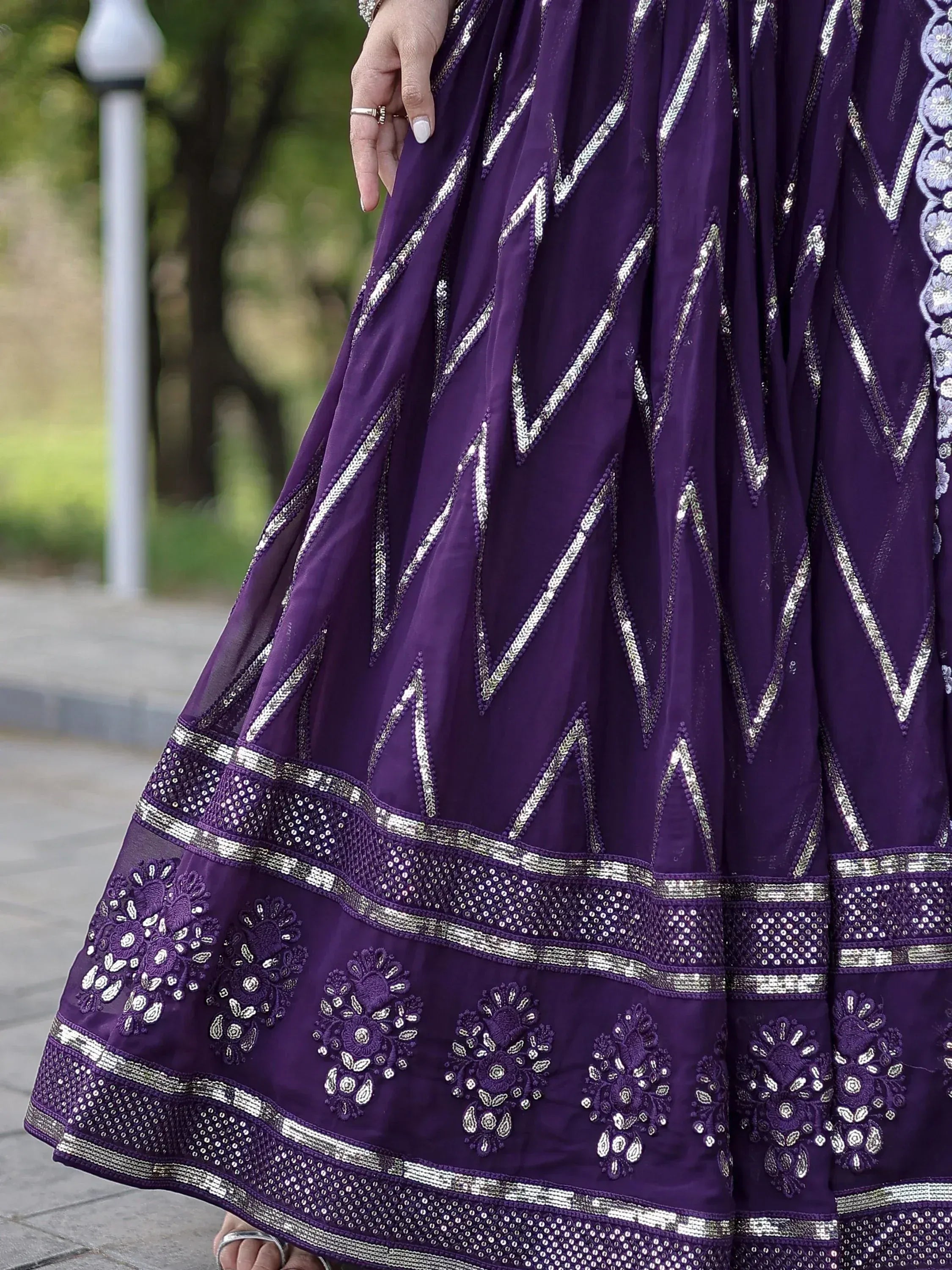 Purple ethnic gown with silver zigzag and floral embroidery, perfect for Indian festive occasions