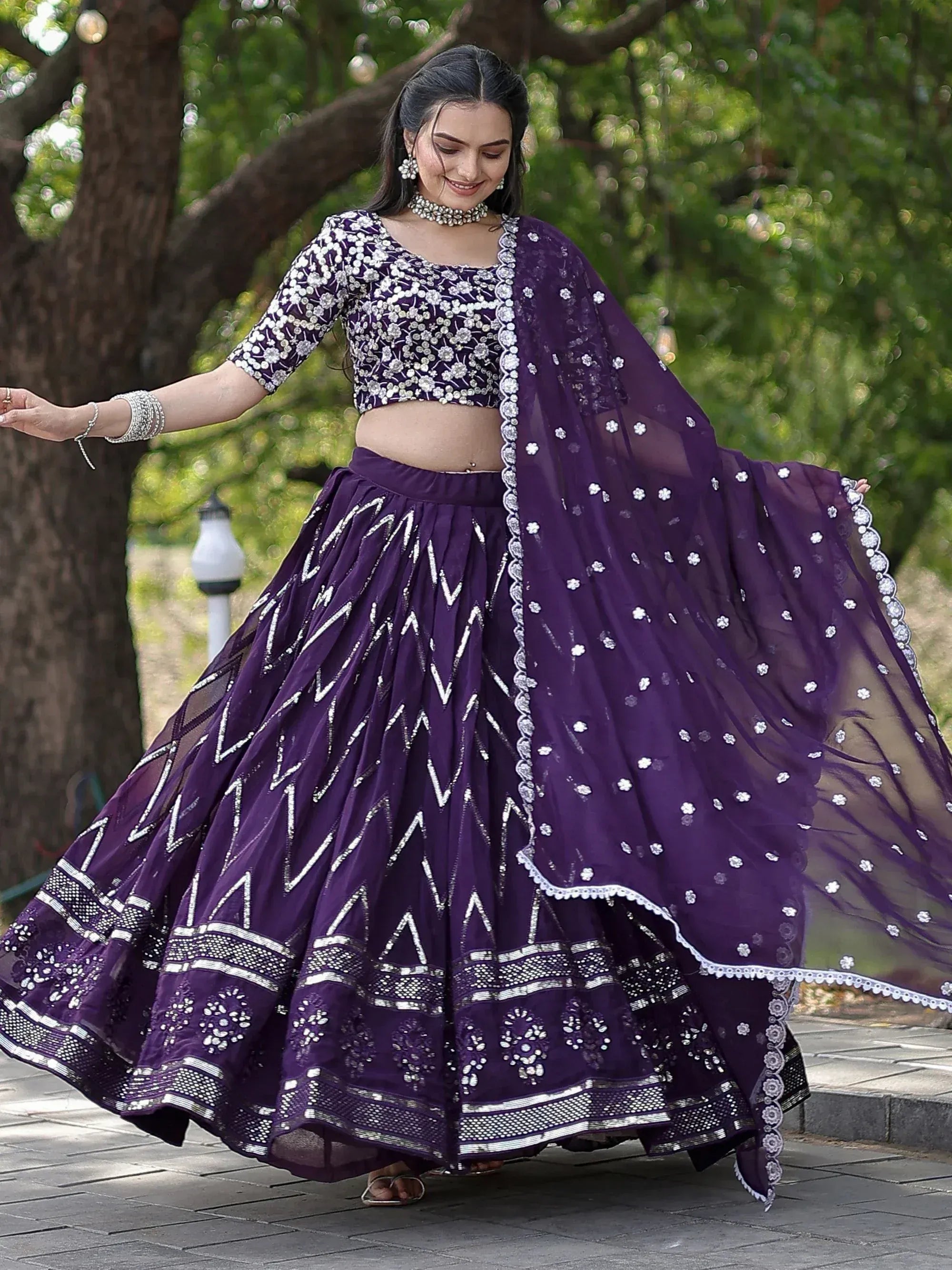 Purple embroidered lehenga choli with floral motifs, perfect for Indian ethnic wear occasions.