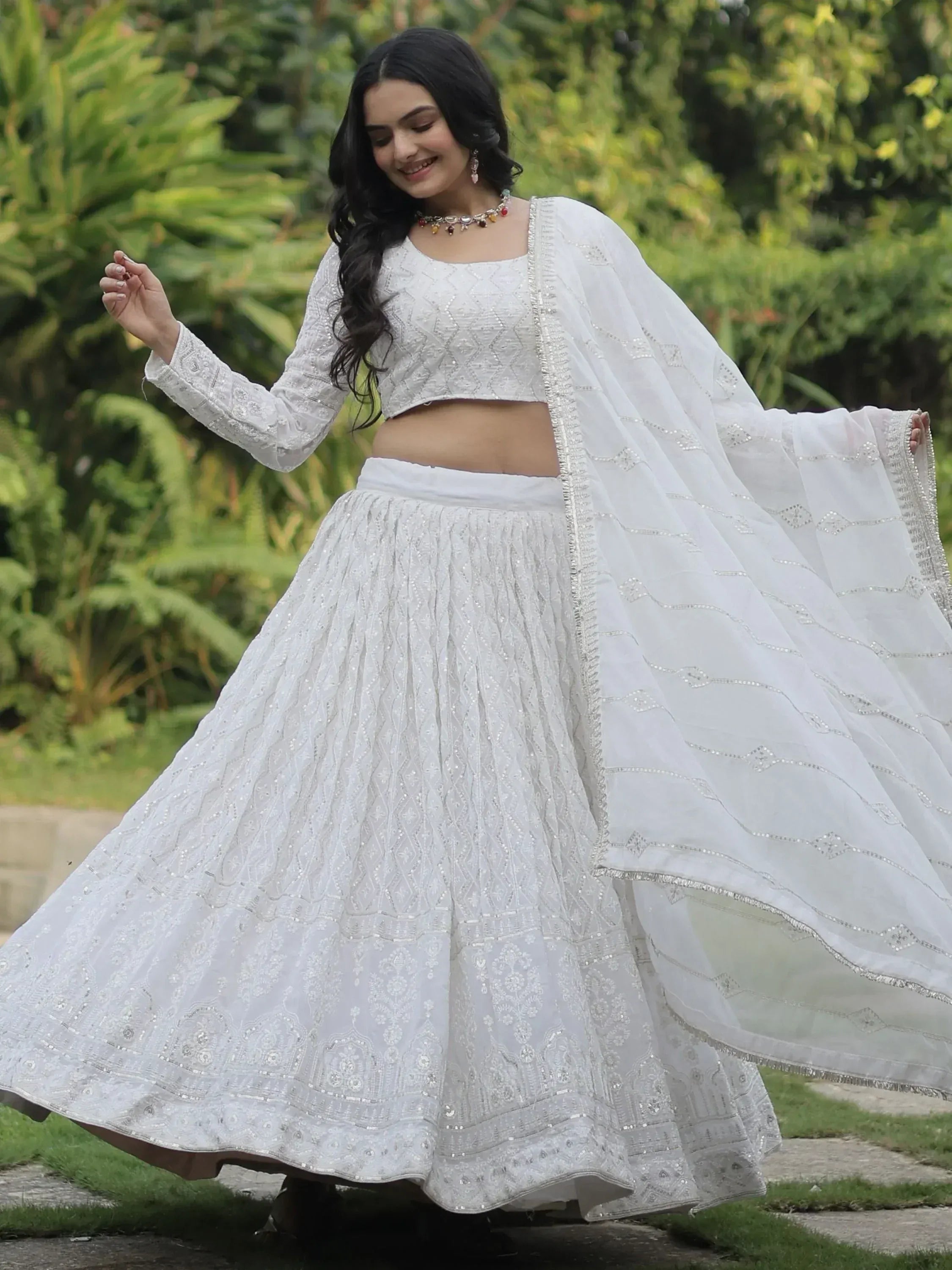 Elegant white embroidered lehenga choli with dupatta, perfect for Indian ethnic occasions and weddings.