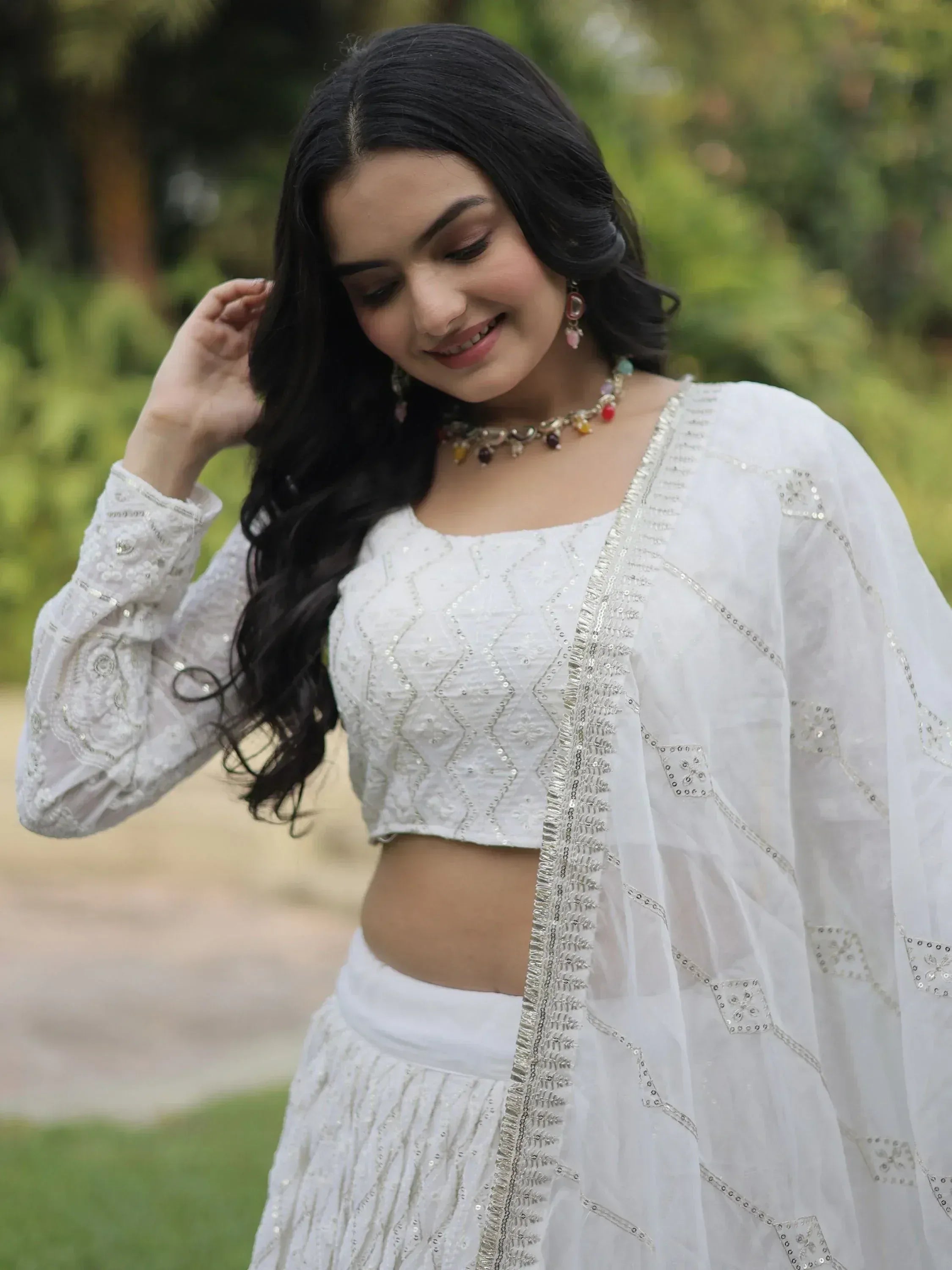 White embroidered lehenga choli with sheer dupatta, perfect for Indian ethnic wear occasions.