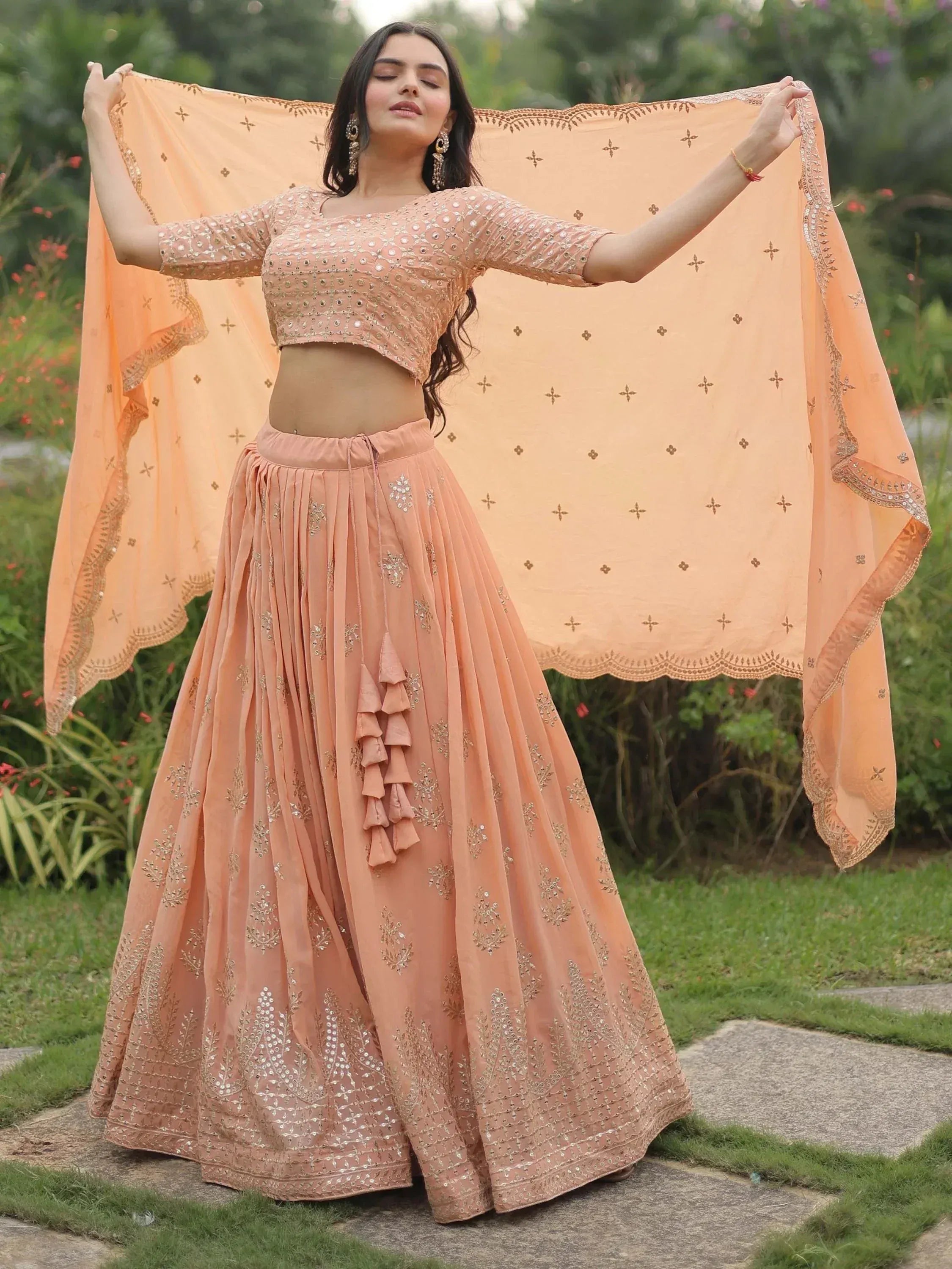 Peach designer lehenga choli with mirror work, pleated skirt, and dupatta for Indian ethnic wear