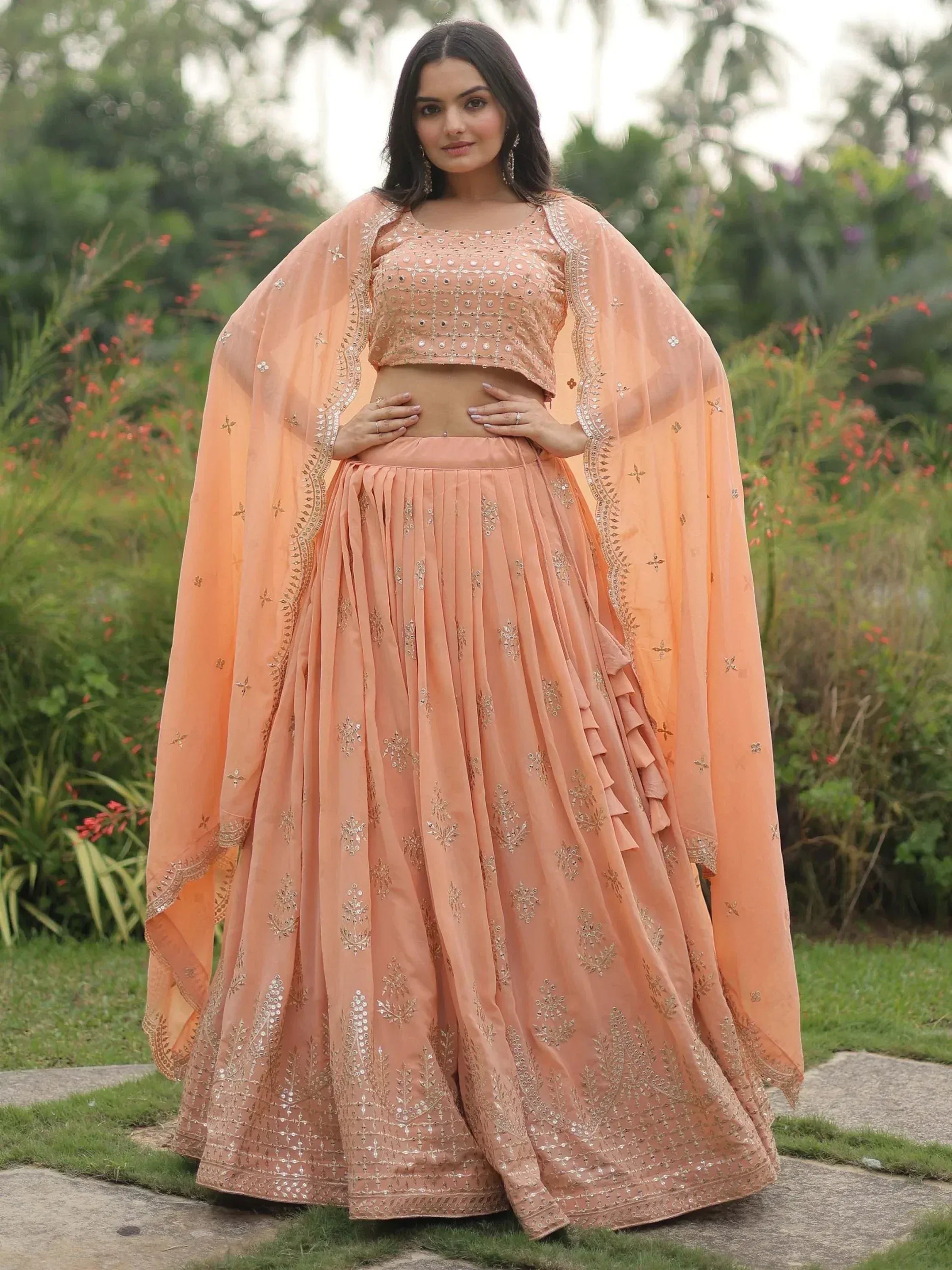 Peach designer lehenga choli with gold embroidery, perfect for Indian ethnic wear events
