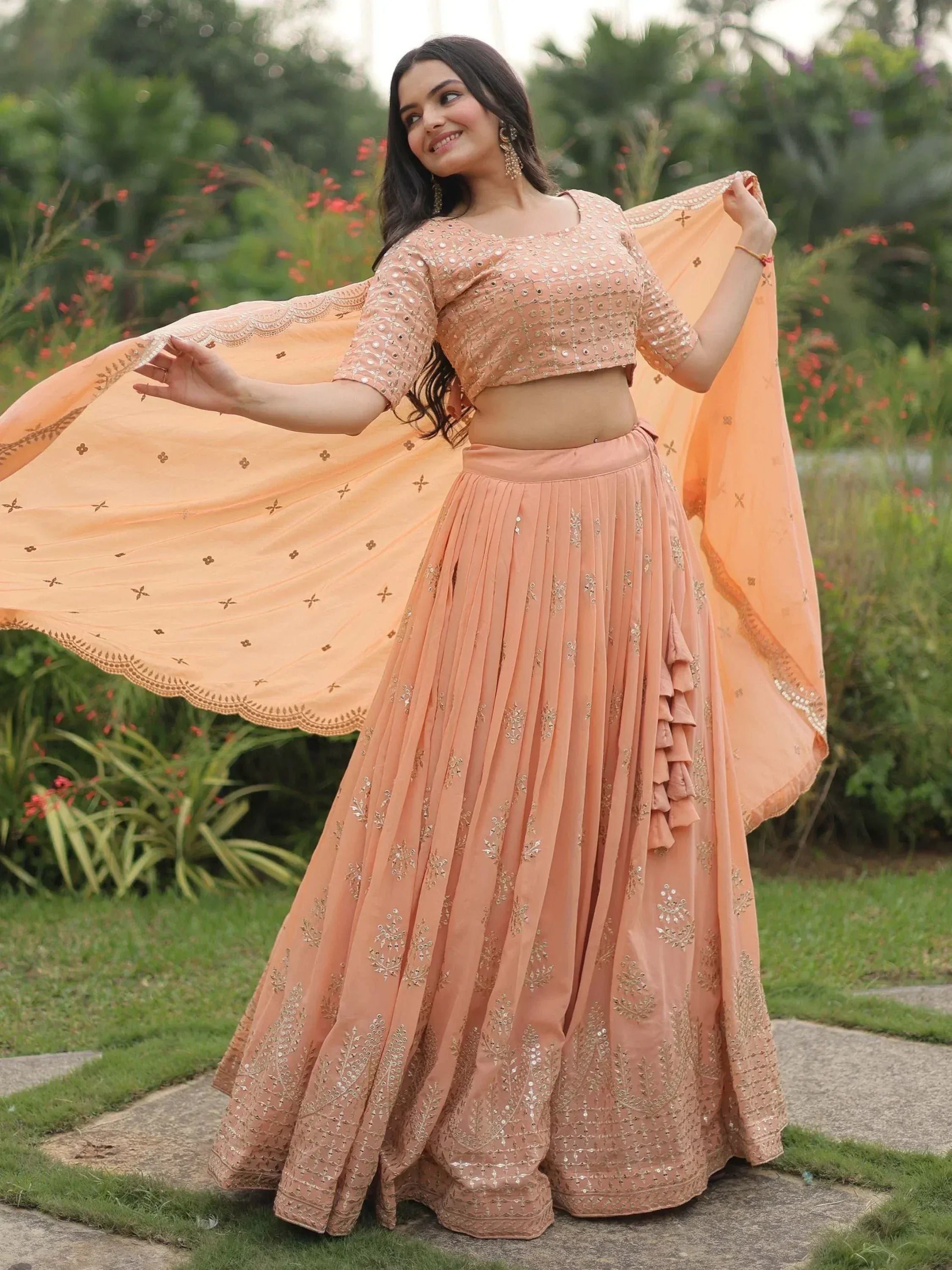 Peach designer lehenga choli with gold embroidery, perfect for Indian ethnic wear and festive occasions.