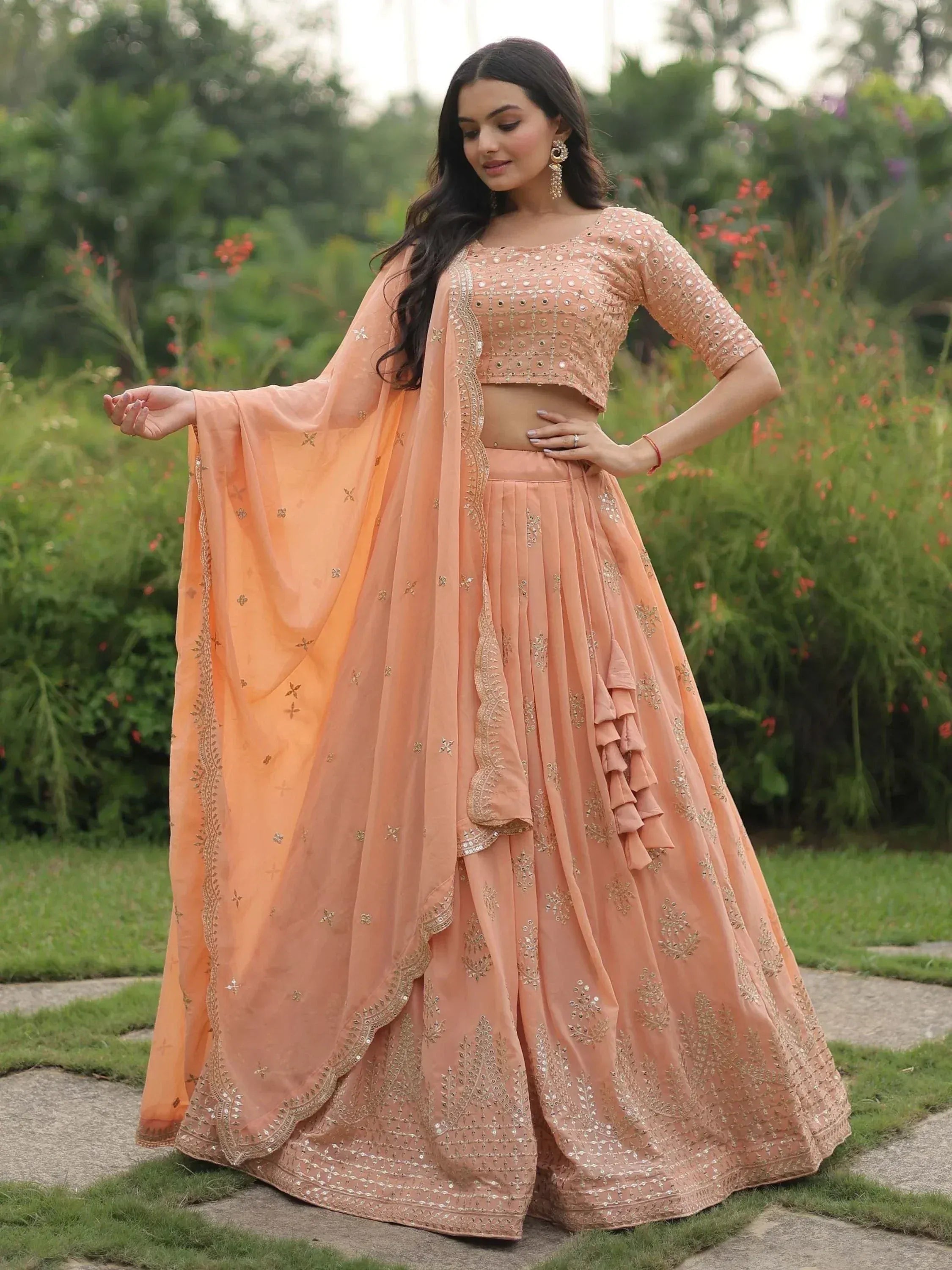 Peach designer lehenga choli with gold embroidery, perfect for Indian weddings and festive occasions