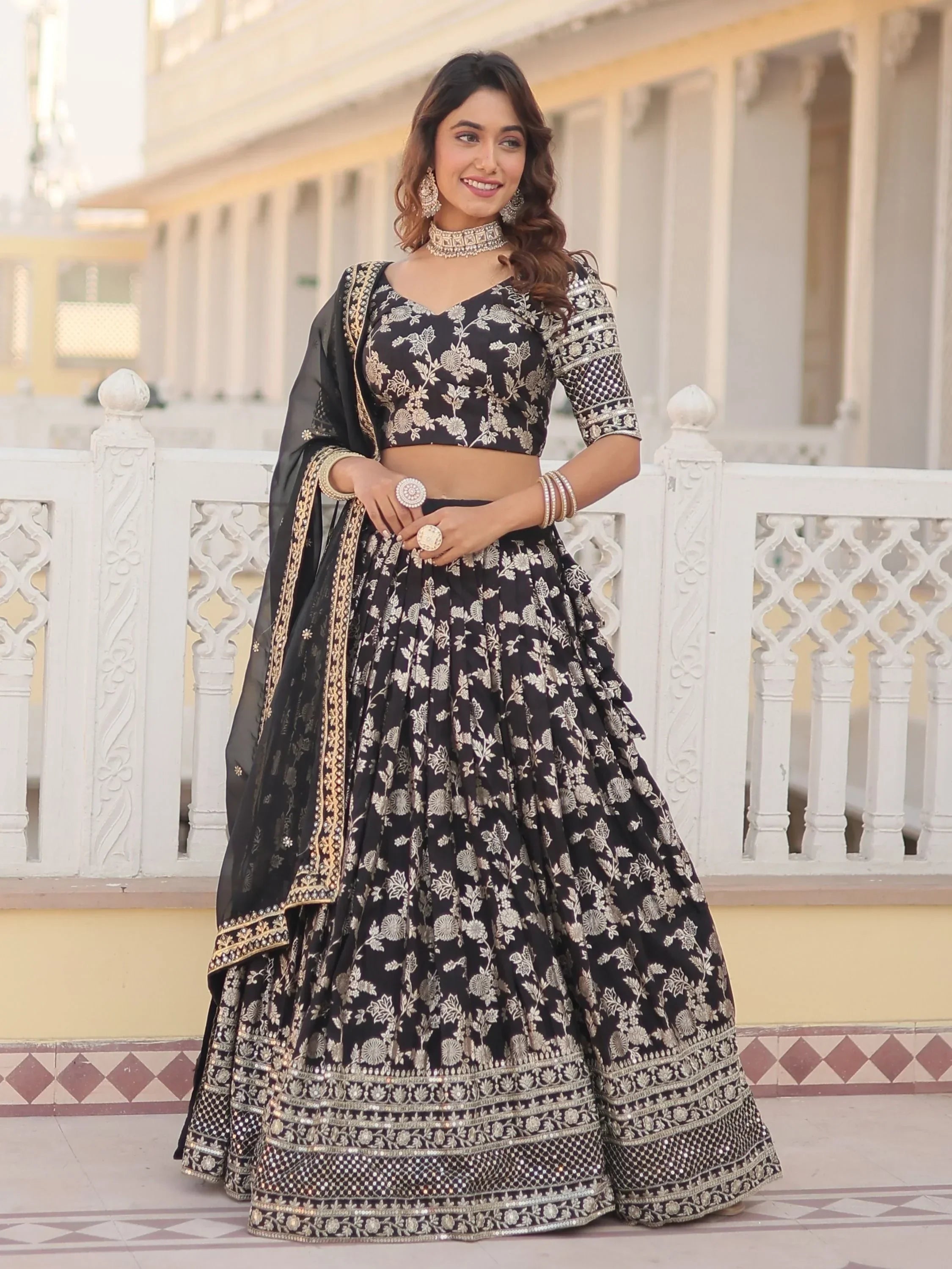 Black and gold embroidered lehenga choli with floral design, perfect for Indian ethnic wear occasions.