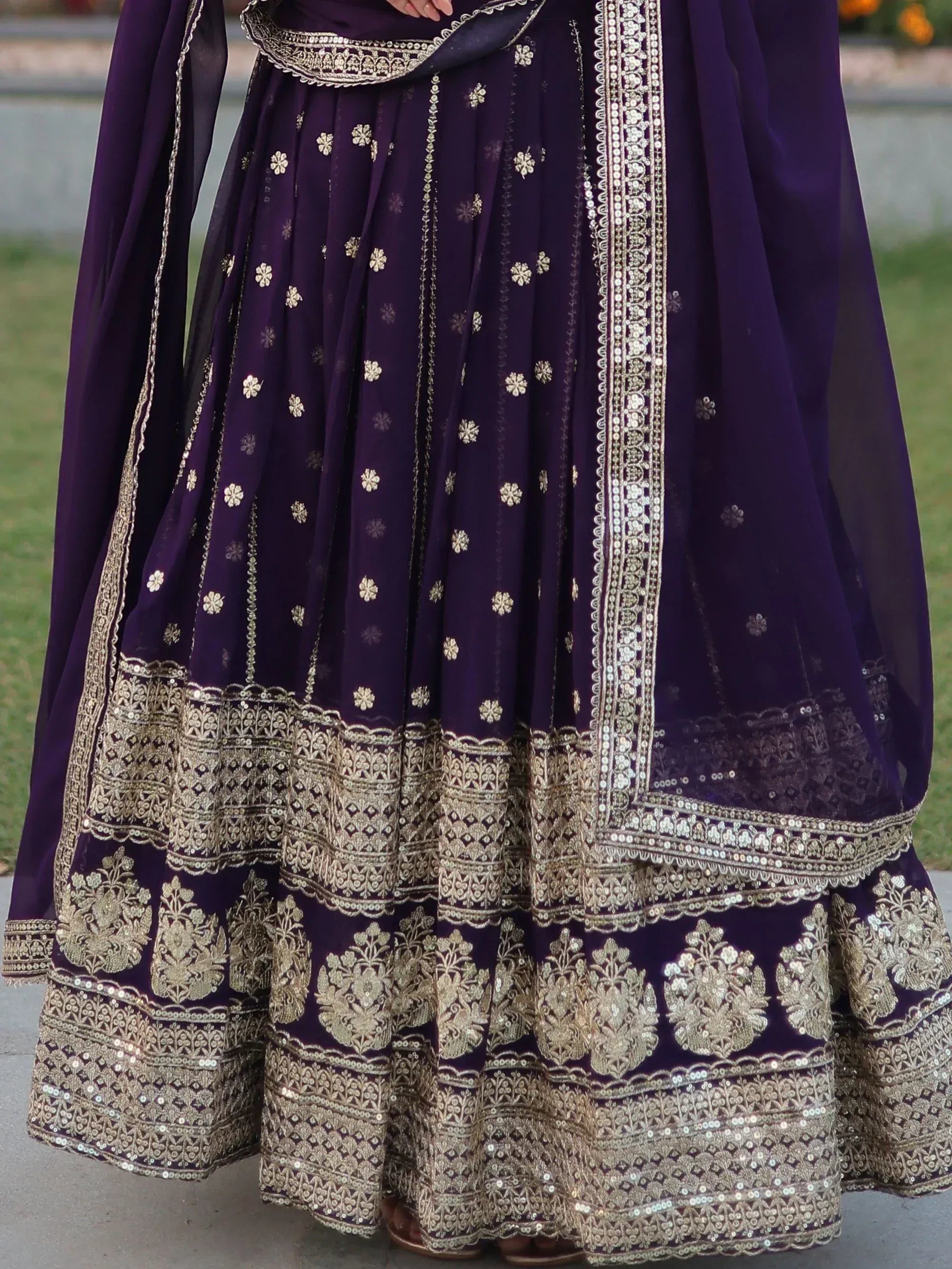 Purple designer lehenga choli with gold embroidery and sequin work, perfect for Indian ethnic occasions.