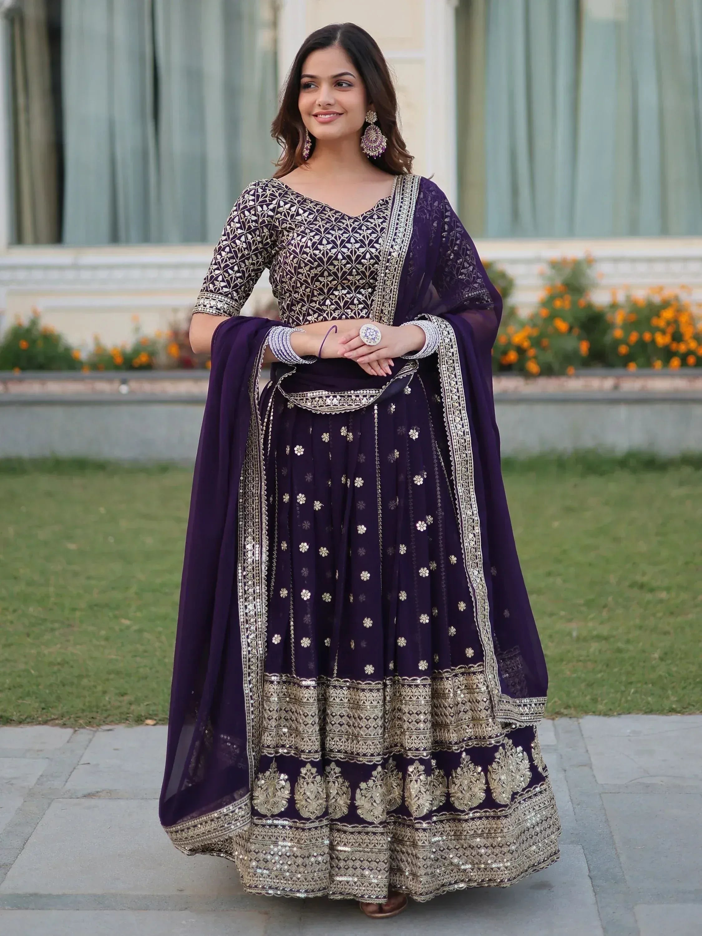 Elegant purple designer lehenga choli with gold embroidery, perfect for Indian ethnic wear occasions.