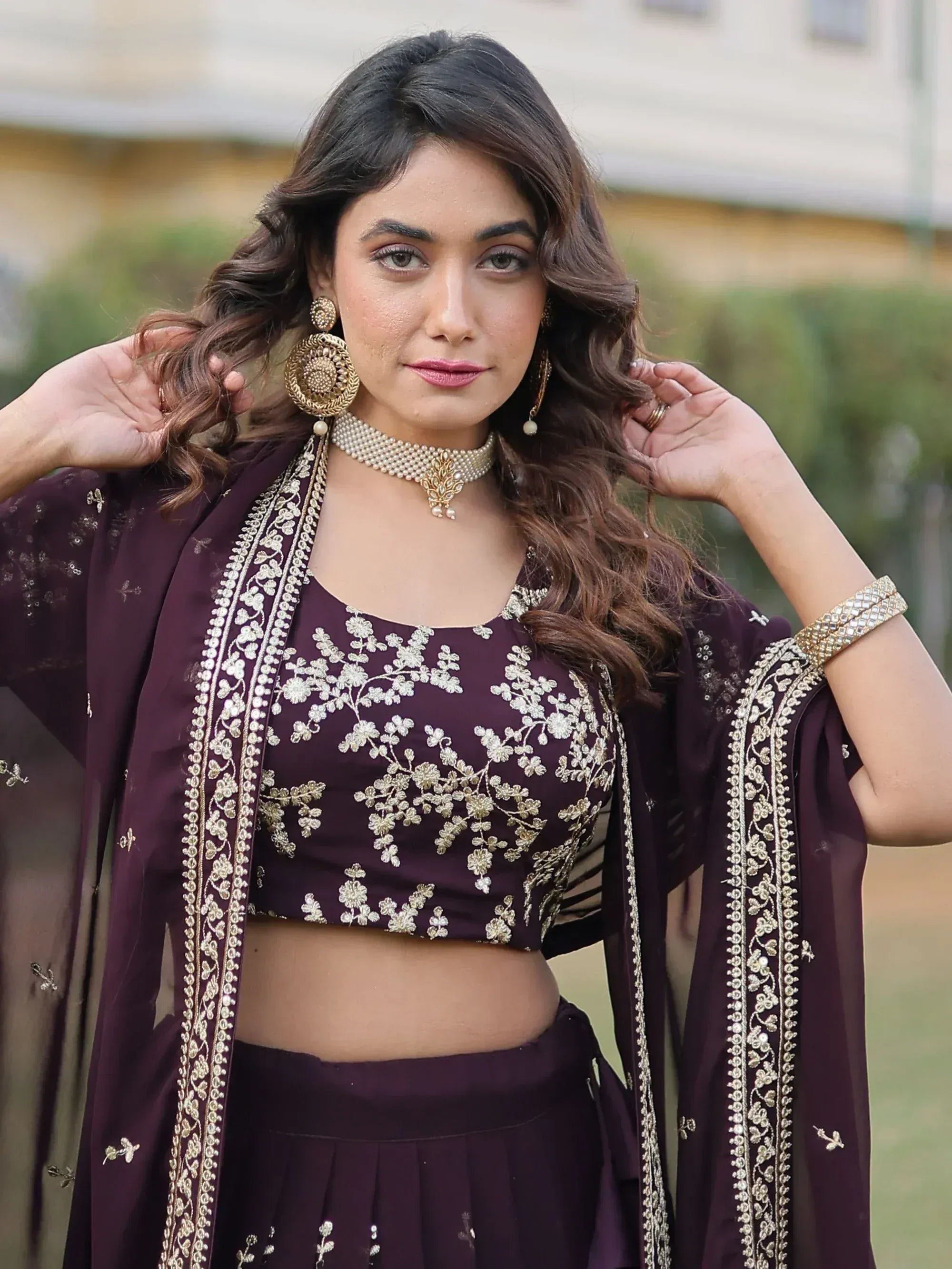 Elegant purple ethnic lehenga choli with gold floral embroidery and matching dupatta, perfect for Indian weddings or festivals.