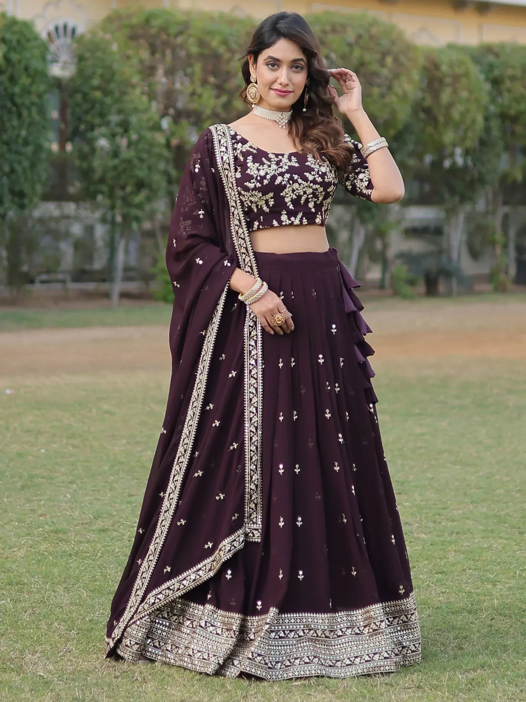 Elegant purple lehenga choli with gold embroidery, perfect for Indian weddings and festive occasions.