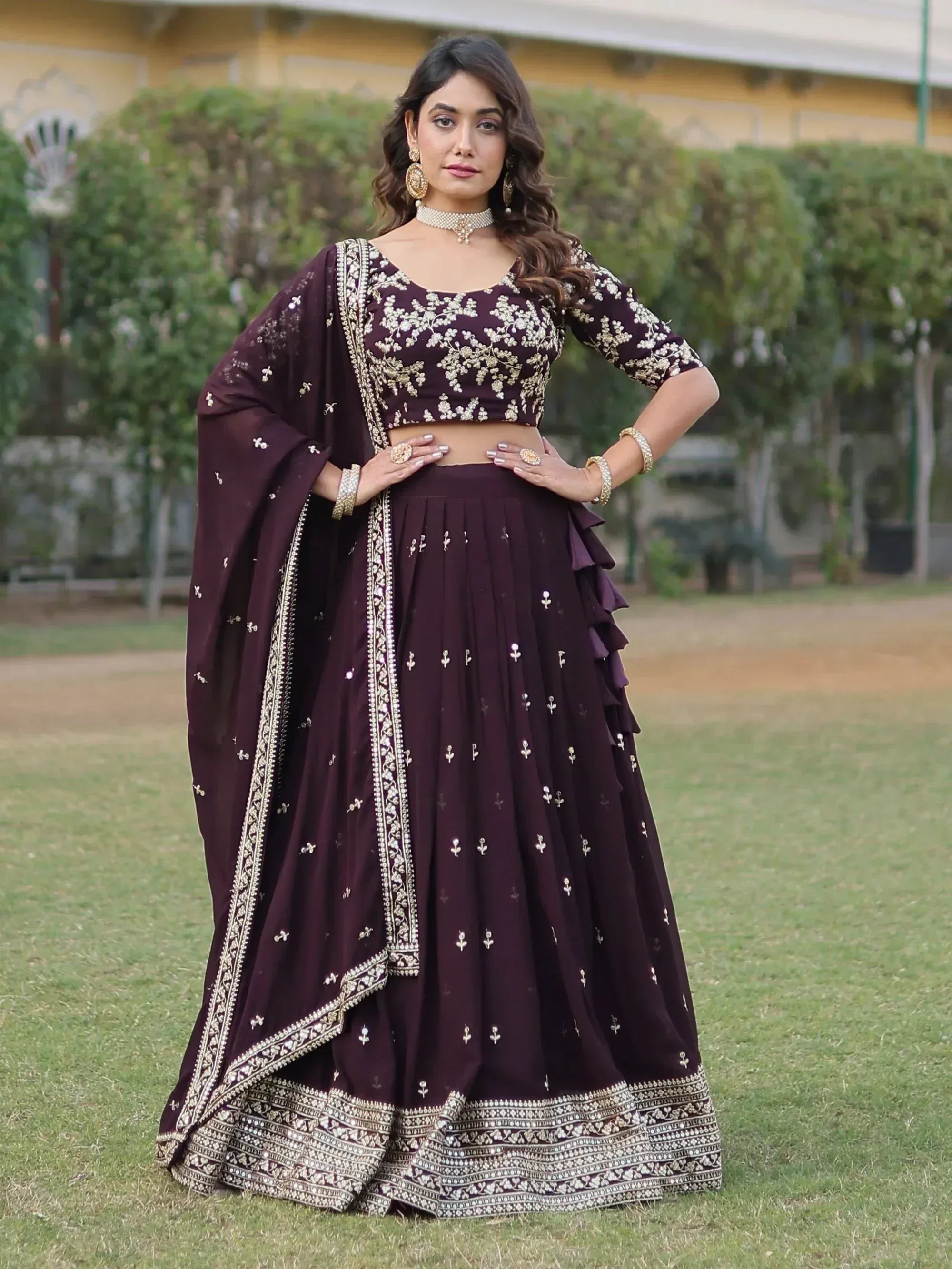 Elegant maroon lehenga choli with gold embroidery, perfect for Indian ethnic wear occasions.