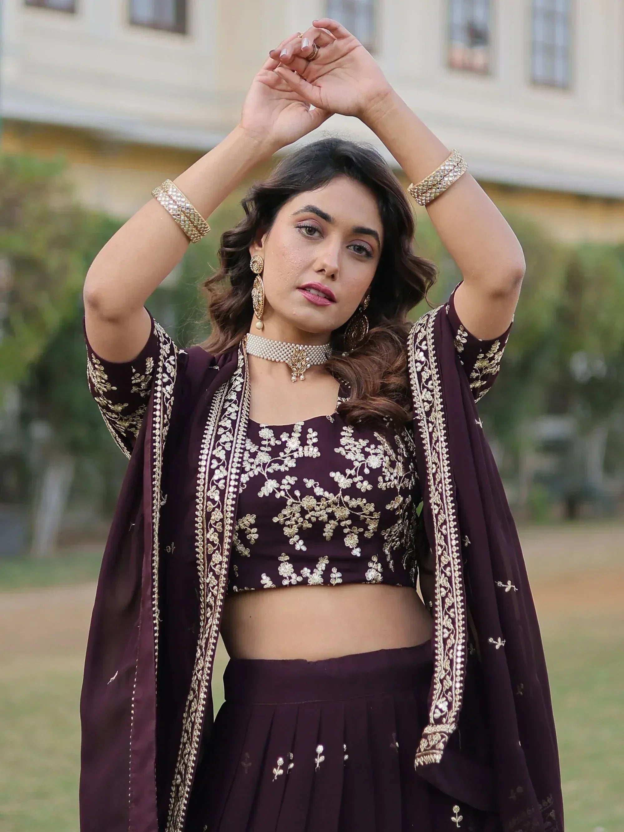 Elegant maroon lehenga choli with gold embroidery, perfect for Indian ethnic wear occasions.