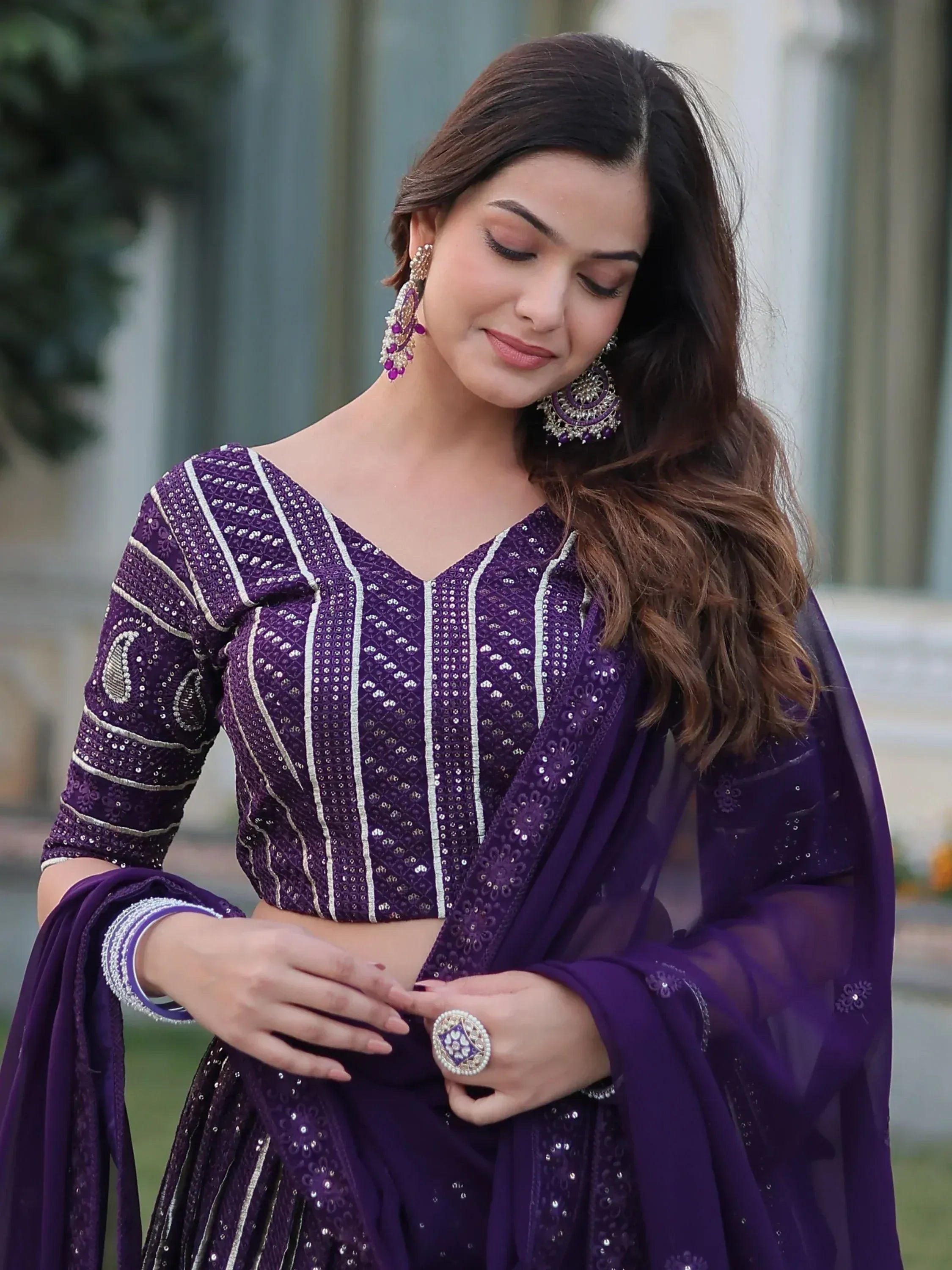 Purple designer lehenga choli with intricate embroidery and matching dupatta, perfect for Indian ethnic wear occasions.