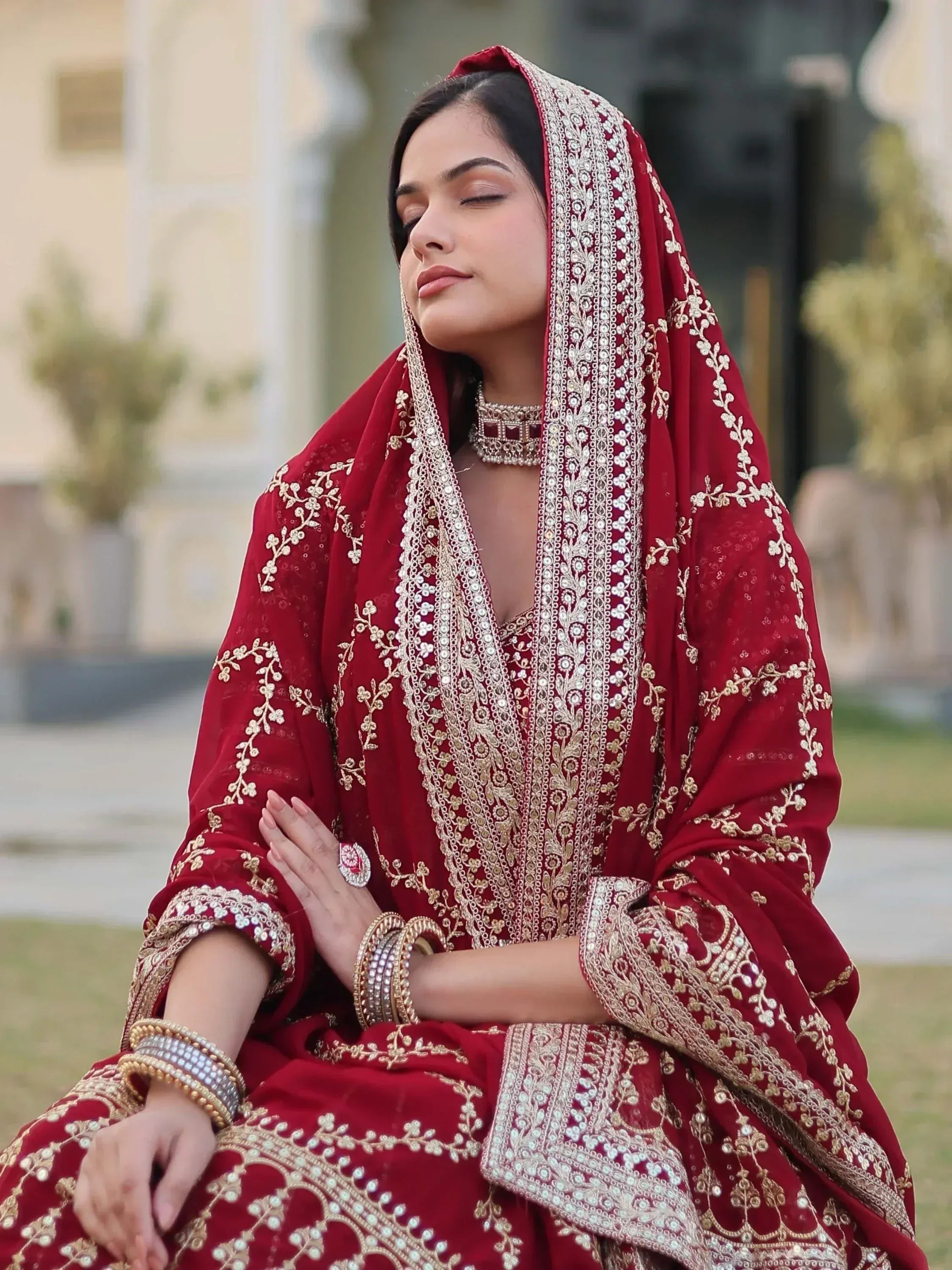 Elegant red embroidered lehenga choli with gold detailing, perfect for Indian weddings and festive occasions.
