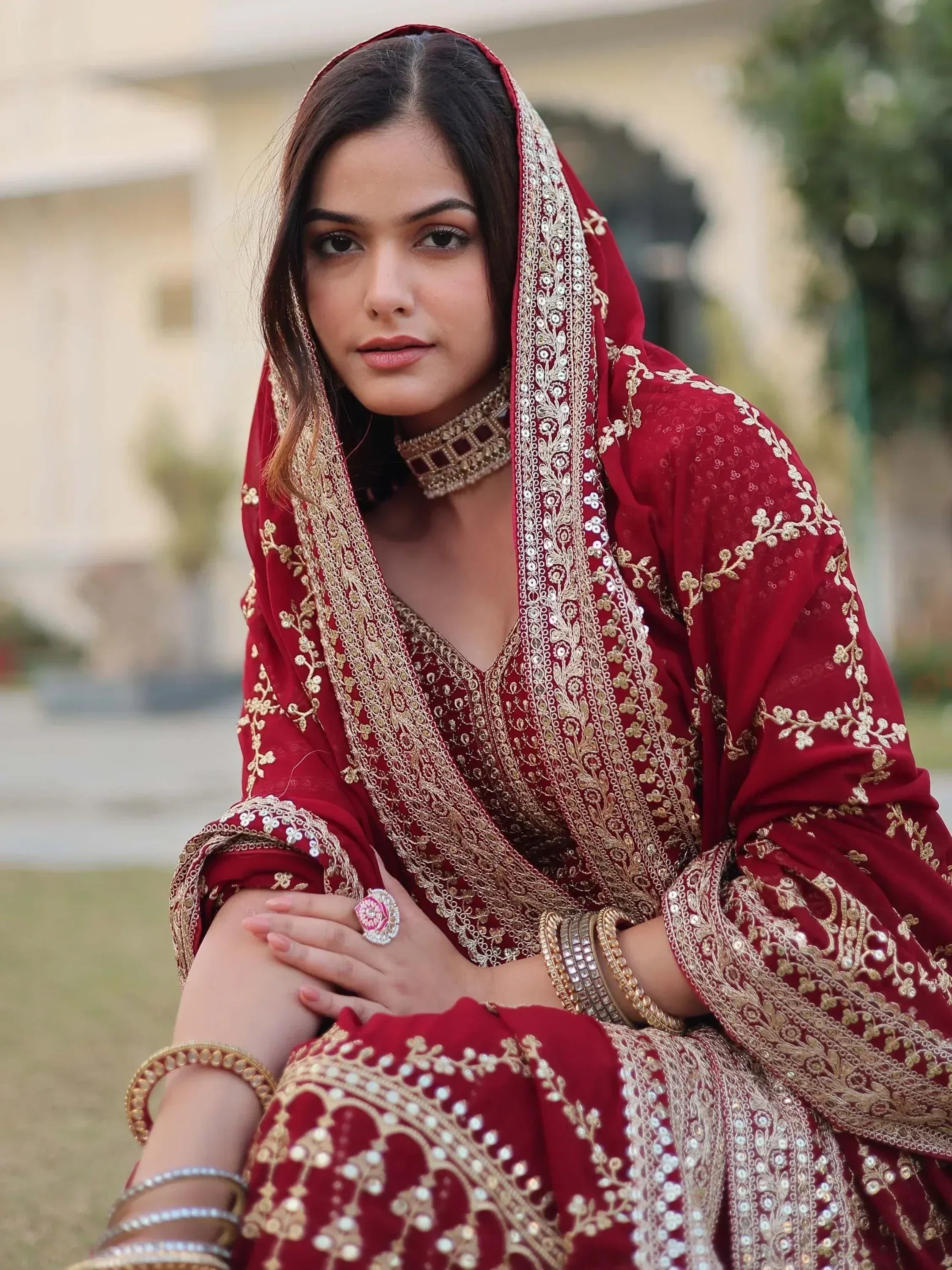 Elegant maroon Indian ethnic wear with gold embroidery, perfect for weddings and festive occasions.