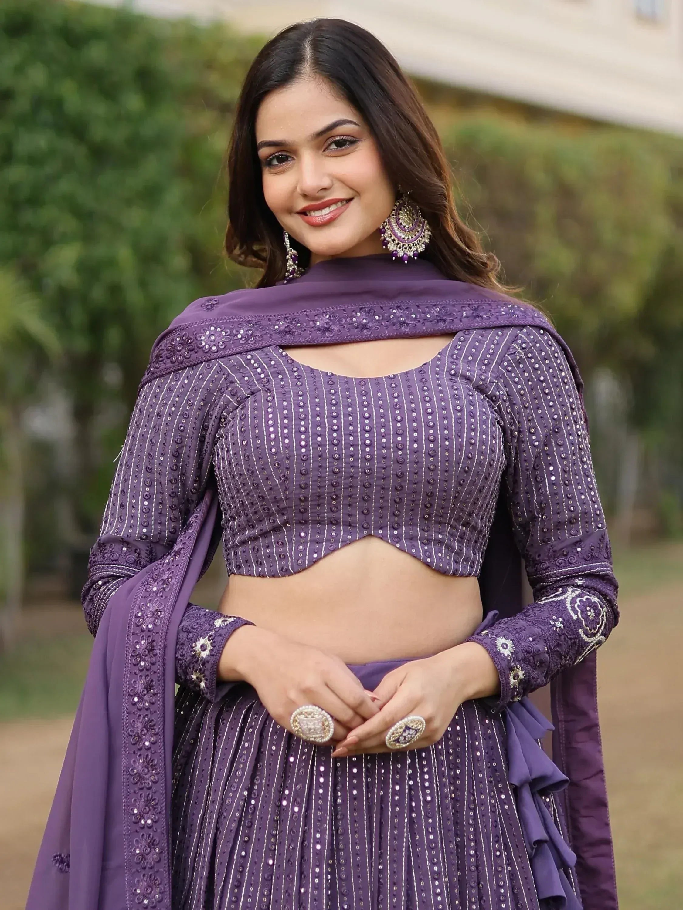 Purple embroidered lehenga choli with sequin detailing and matching dupatta, perfect for Indian ethnic occasions.