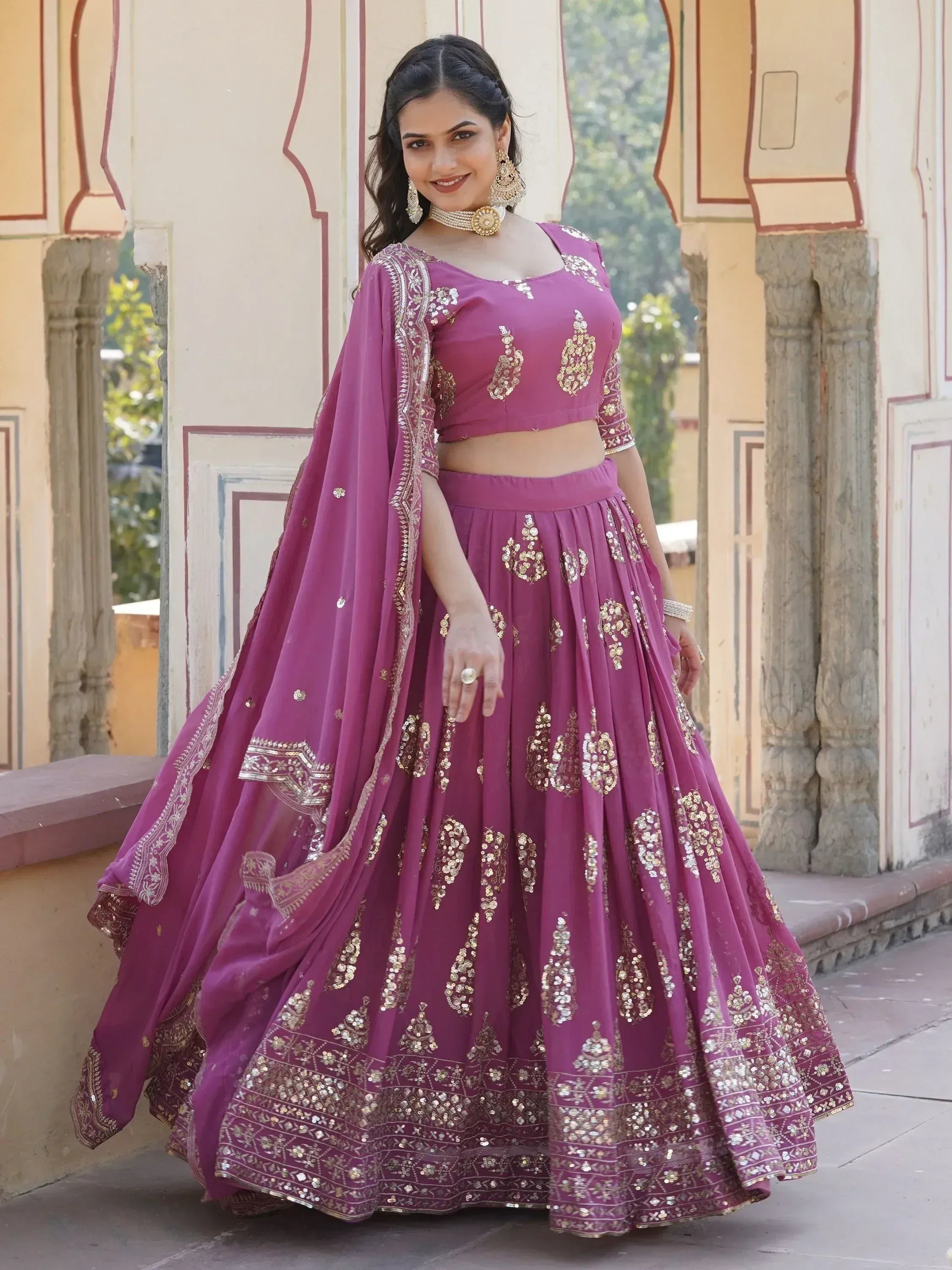 Purple designer lehenga choli with gold embroidery, perfect for Indian weddings and festive occasions.