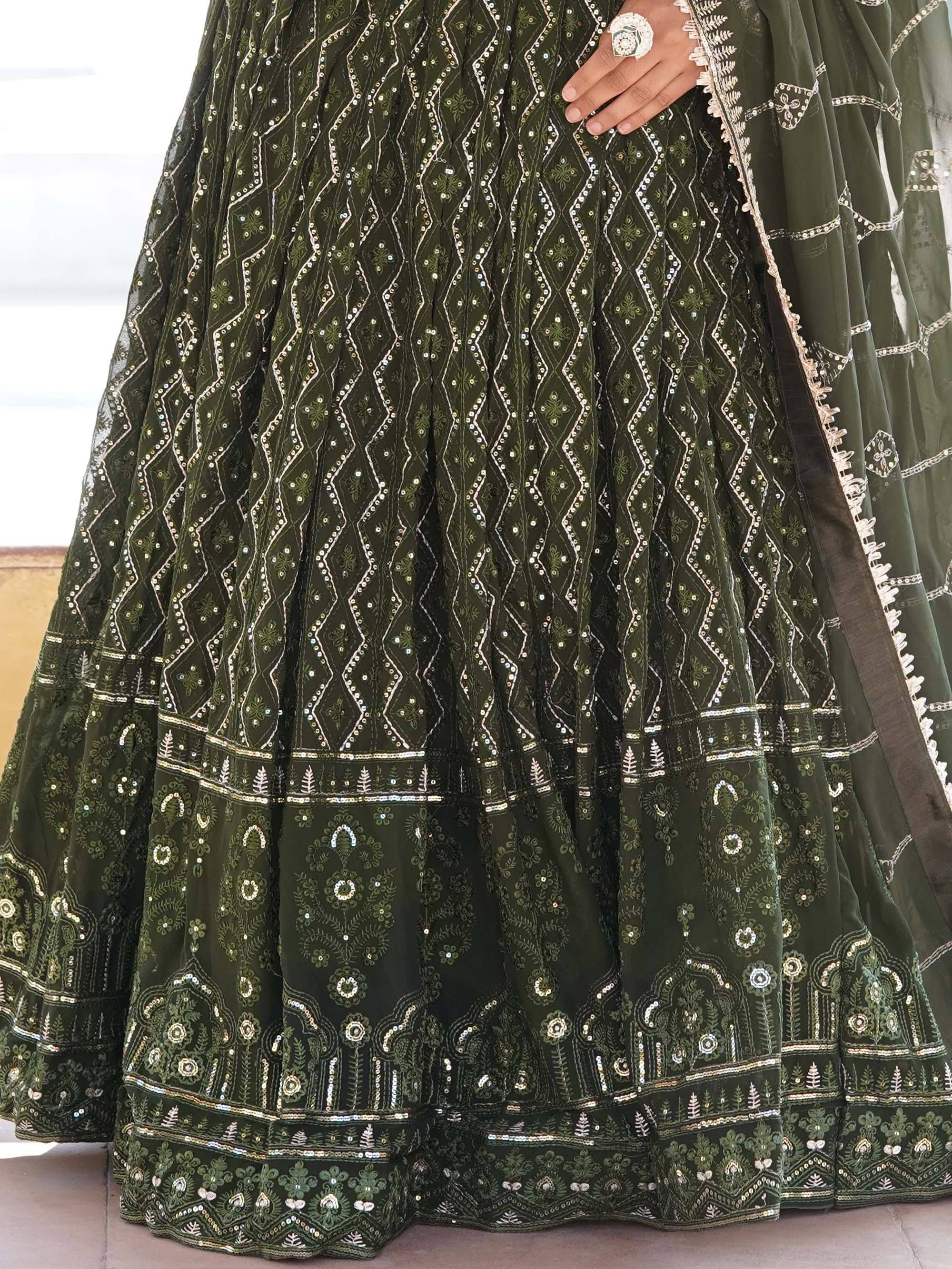 Olive green embroidered lehenga with intricate mirror work and floral patterns, perfect for Indian ethnic wear.