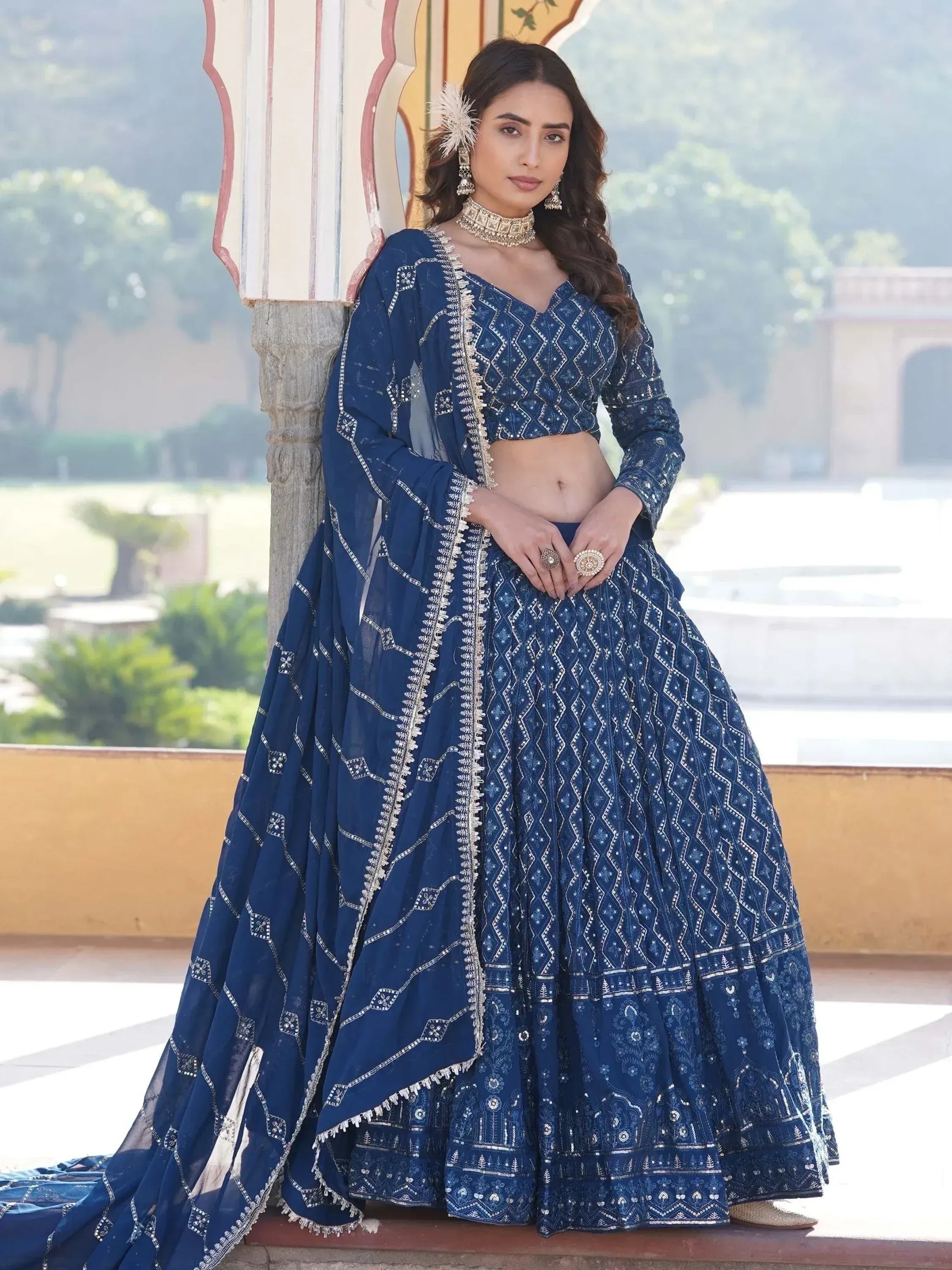Elegant navy blue embroidered lehenga choli with mirror work, perfect for Indian weddings and festive occasions