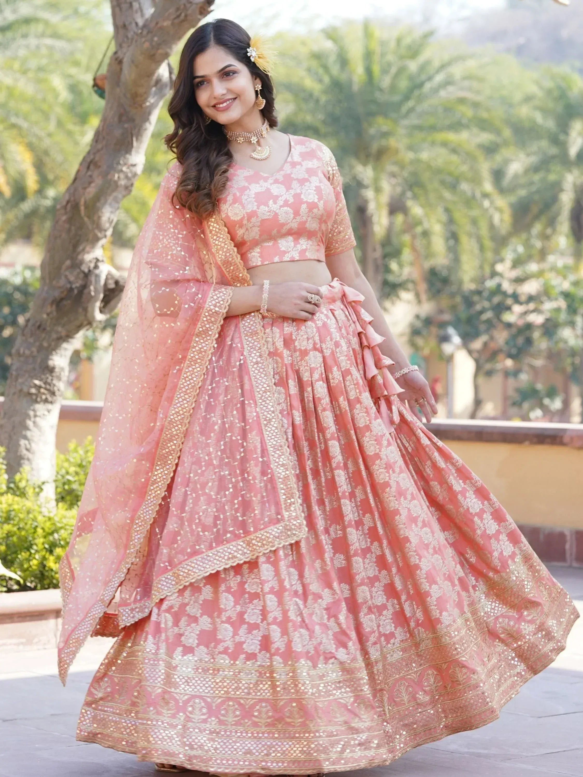 Pink floral lehenga choli with gold embroidery and ruffled skirt, perfect for Indian ethnic wear events