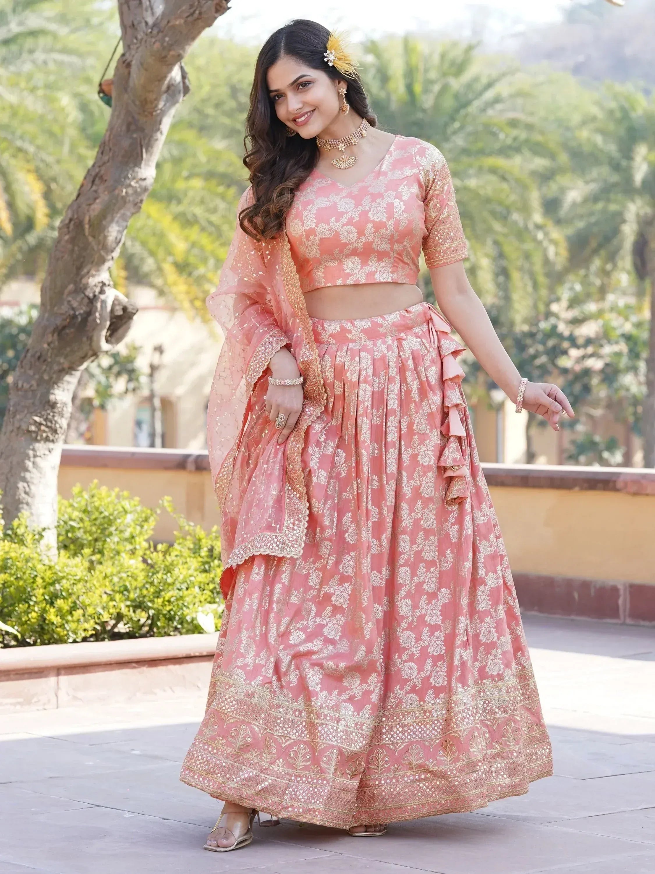 Pink floral lehenga choli with gold embroidery, perfect for Indian weddings and festive occasions.