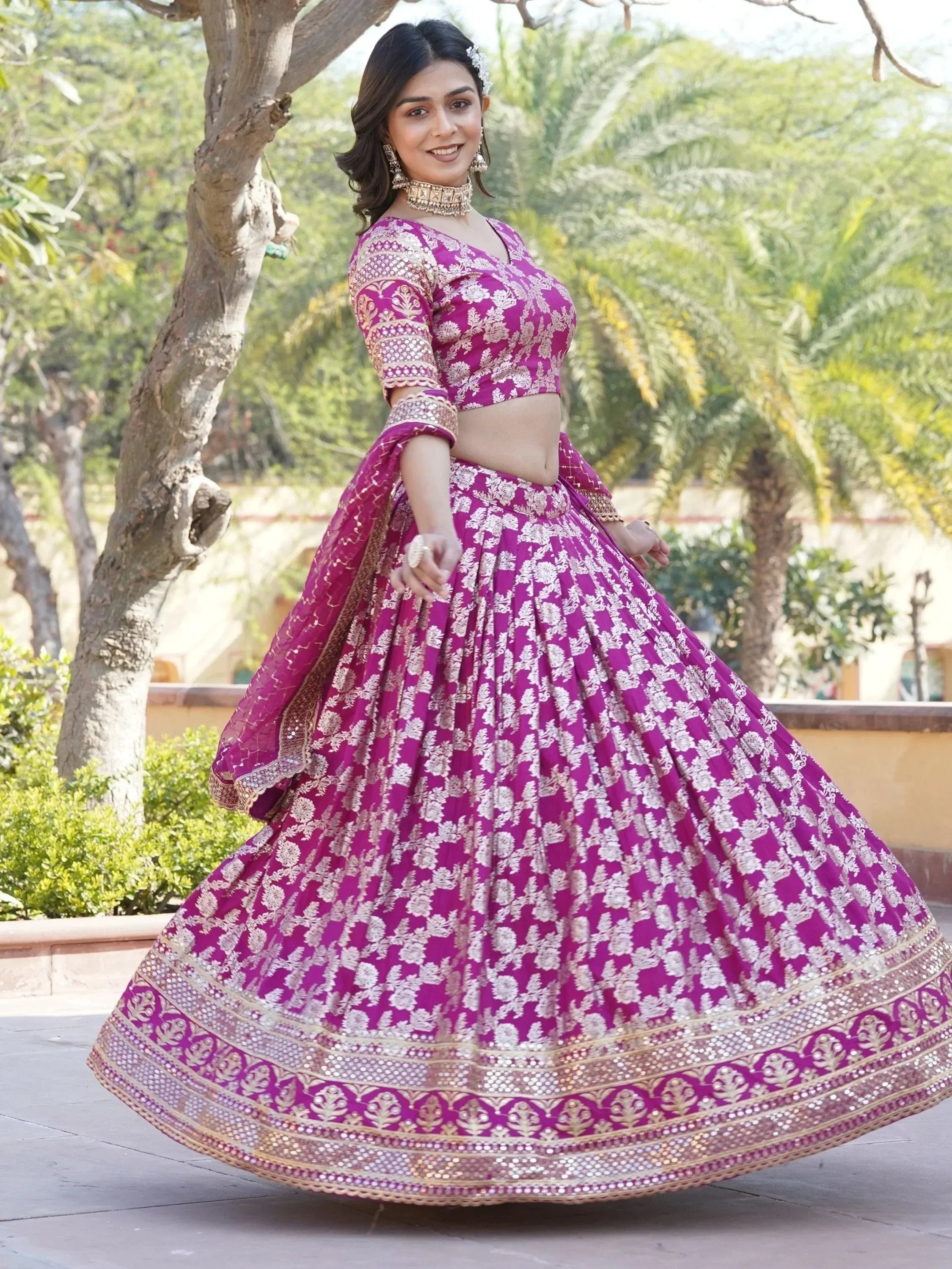 Woman in purple floral lehenga choli with gold embroidery, perfect for Indian weddings and festive occasions