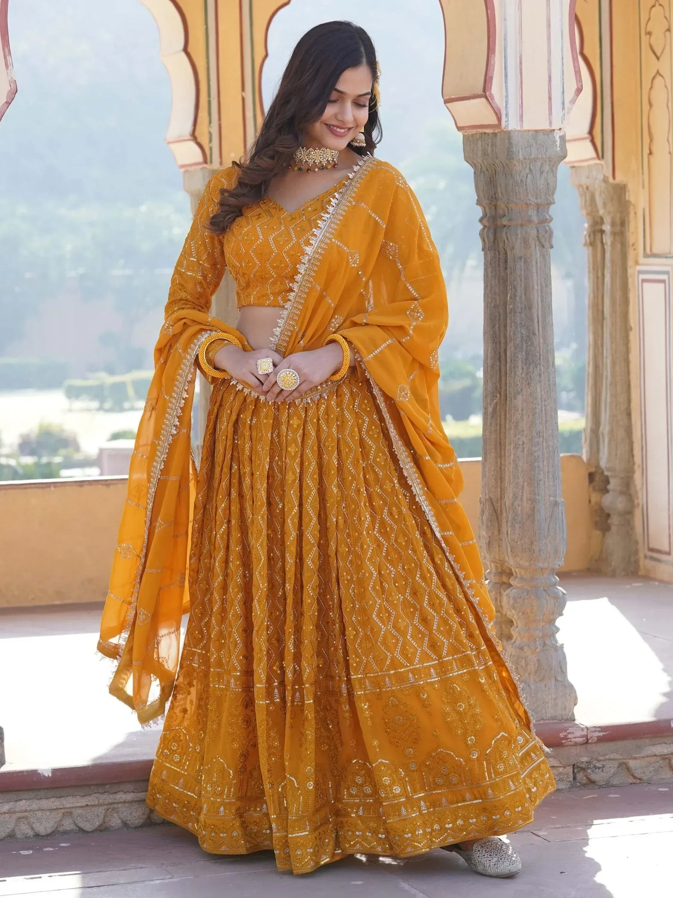 Mustard yellow designer lehenga choli with intricate embroidery, perfect for Indian ethnic wear occasions.