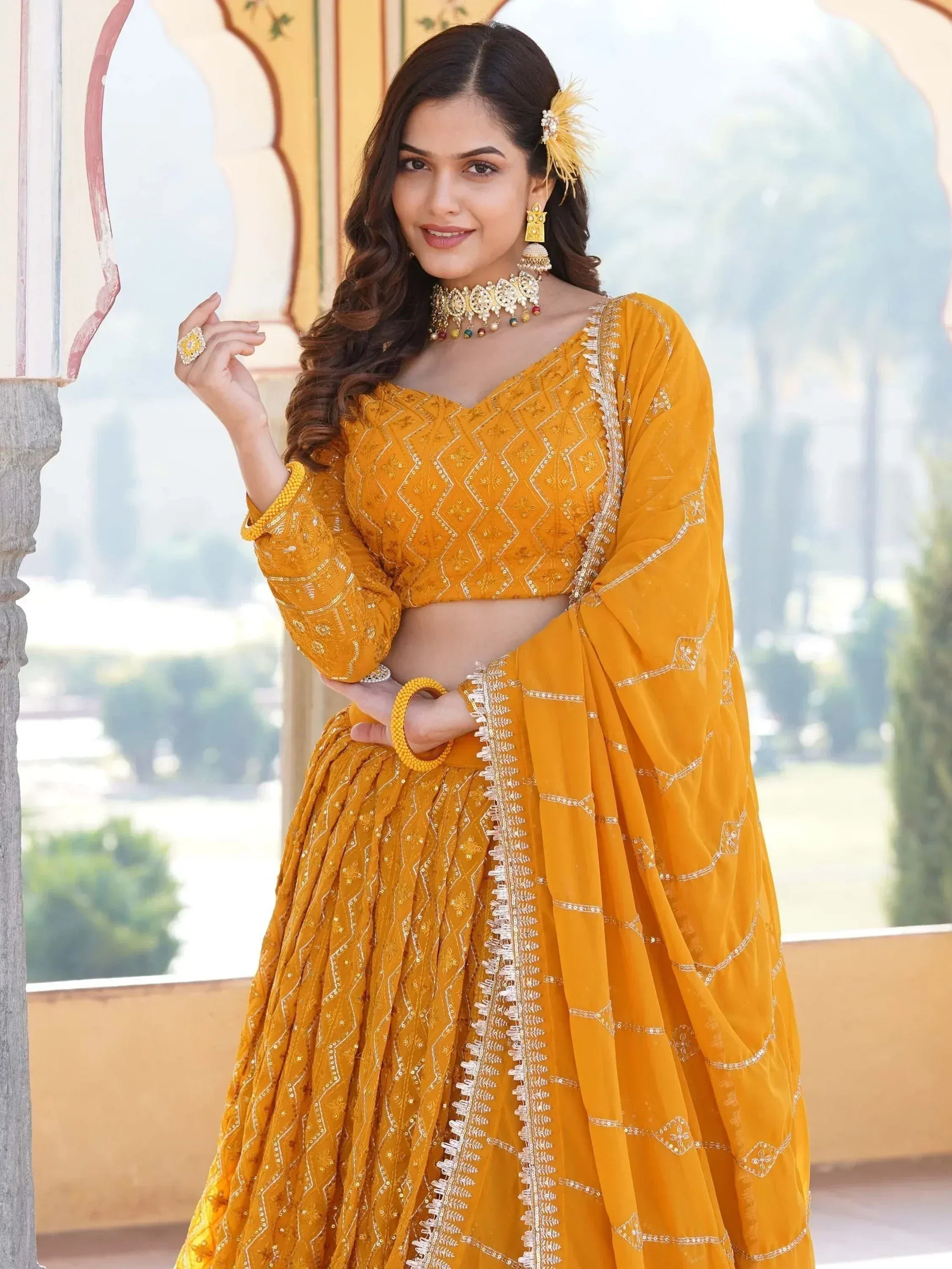 Yellow embroidered lehenga choli with dupatta, traditional Indian ethnic wear for weddings and festivals