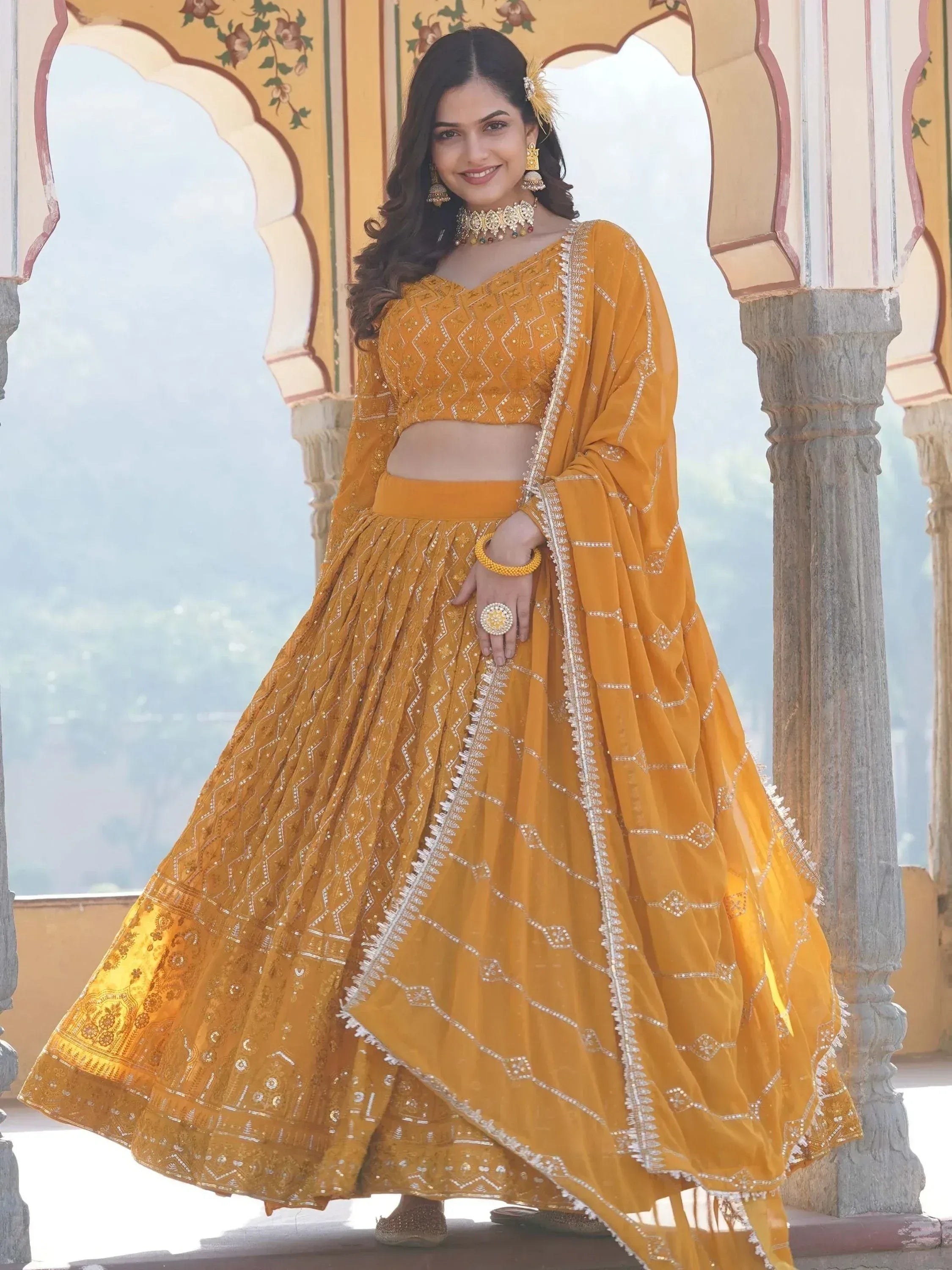 Mustard yellow designer lehenga choli with intricate embroidery and sequin work, perfect for Indian ethnic occasions.