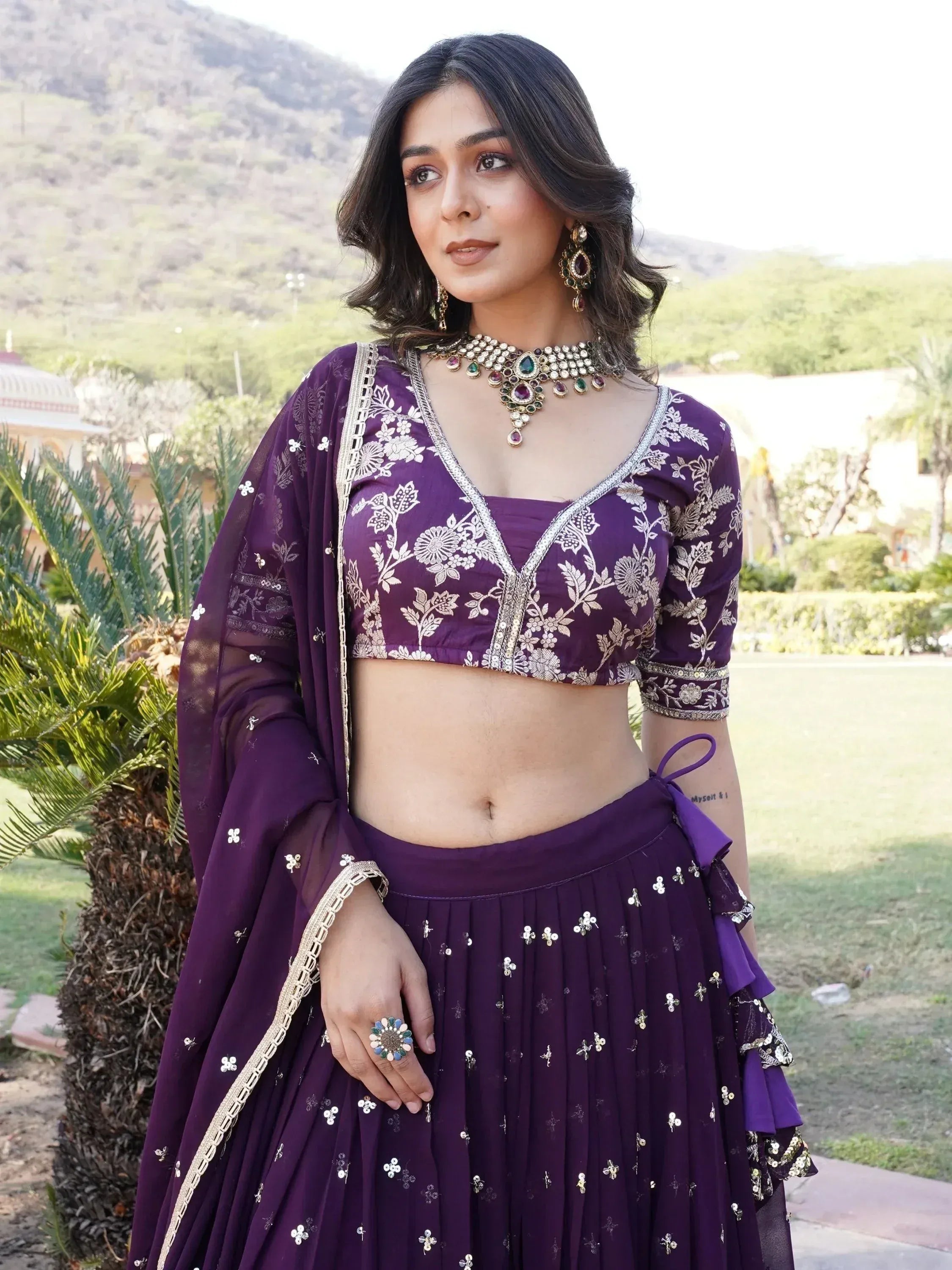 Purple embroidered lehenga choli with floral motifs and gold detailing, perfect for Indian ethnic wear.