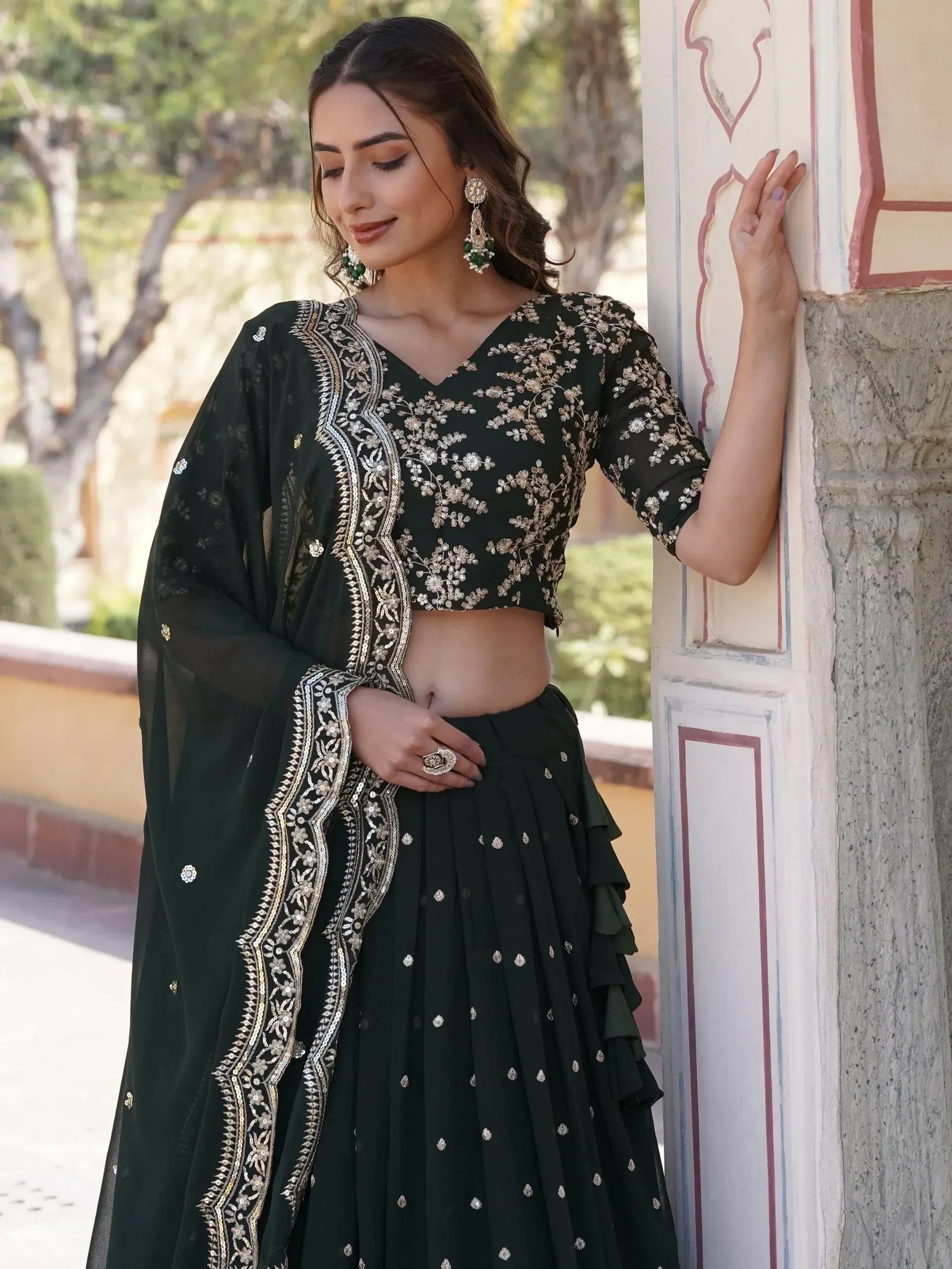 Elegant dark green embroidered lehenga choli with gold detailing, perfect for Indian ethnic wear occasions.