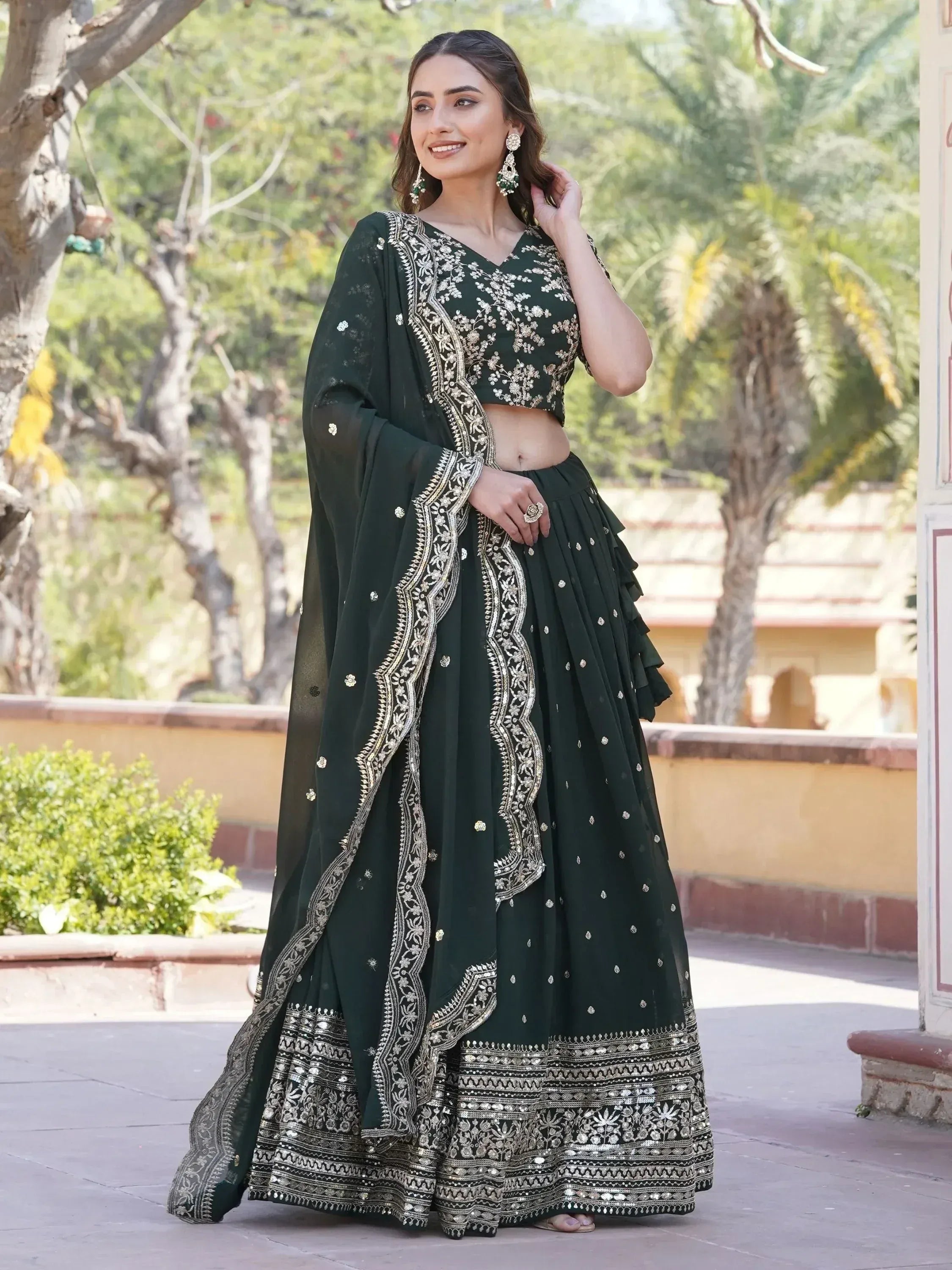 Elegant dark green embroidered lehenga choli with gold detailing, perfect for Indian ethnic wear occasions.