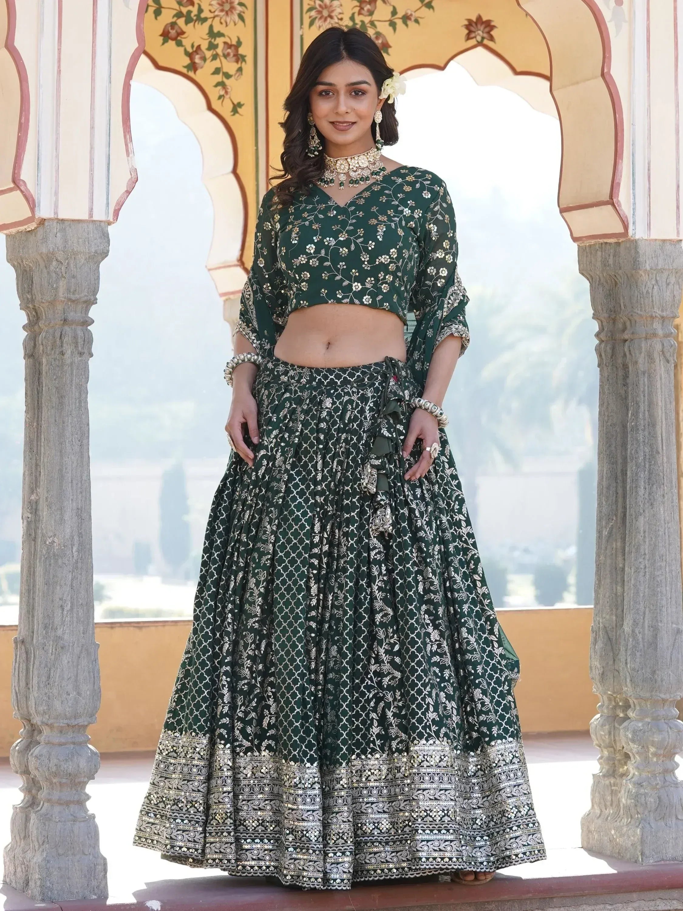 Emerald green embroidered lehenga choli with floral motifs, perfect for Indian weddings and festive occasions.