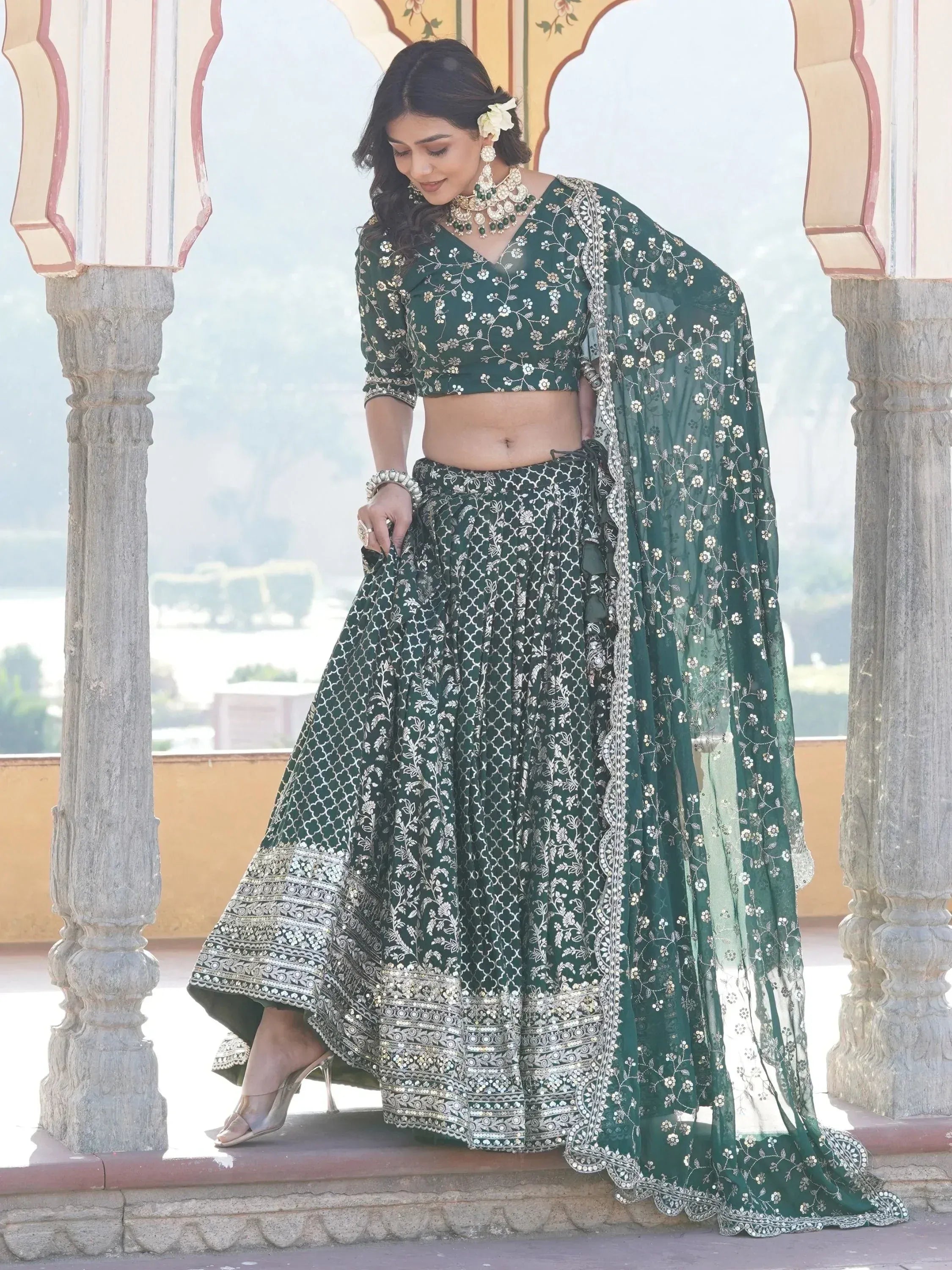 Emerald green embroidered lehenga choli with floral motifs, perfect for Indian ethnic occasions