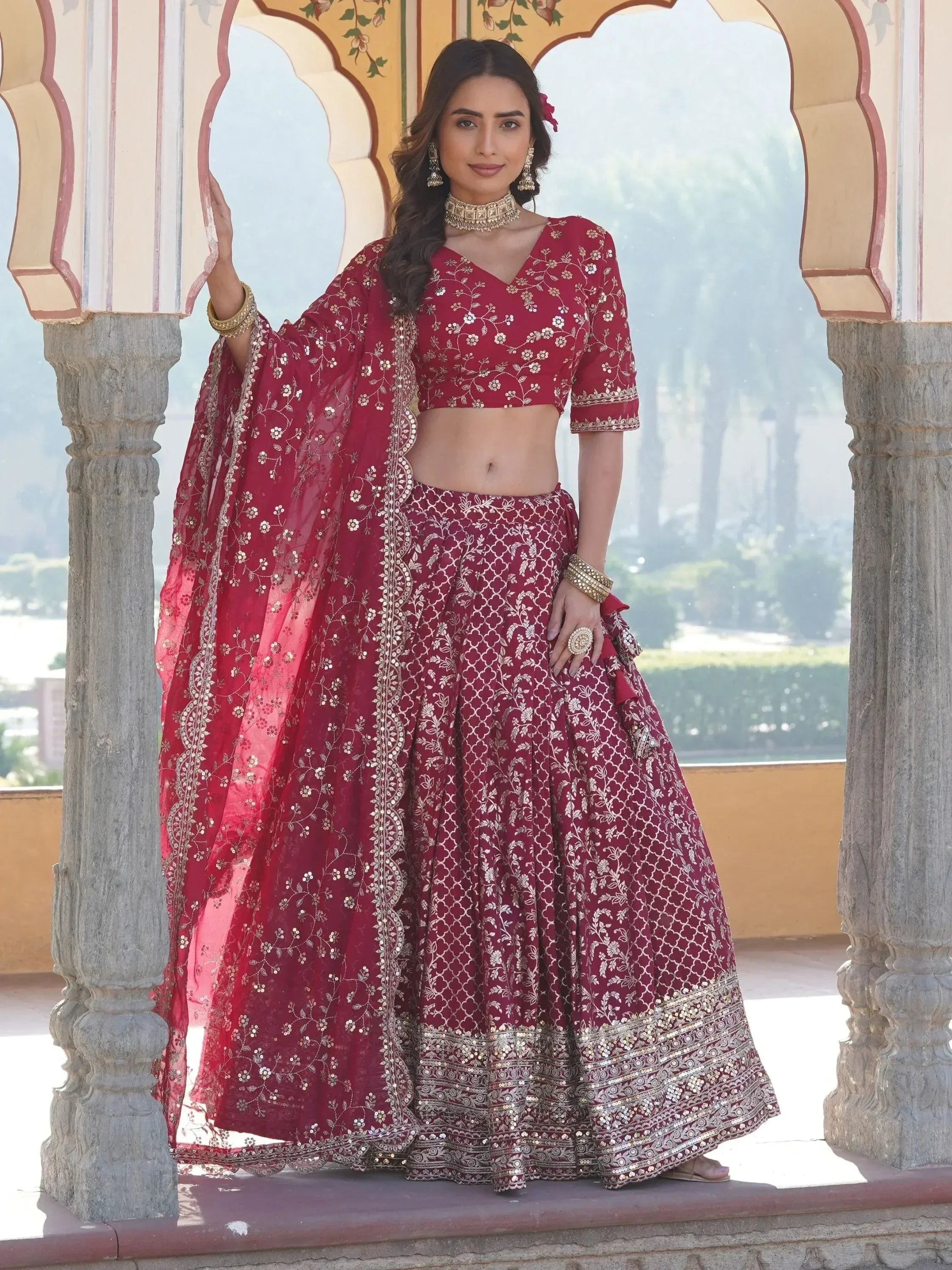 Maroon embroidered lehenga choli with gold detailing, perfect for Indian weddings and festive occasions