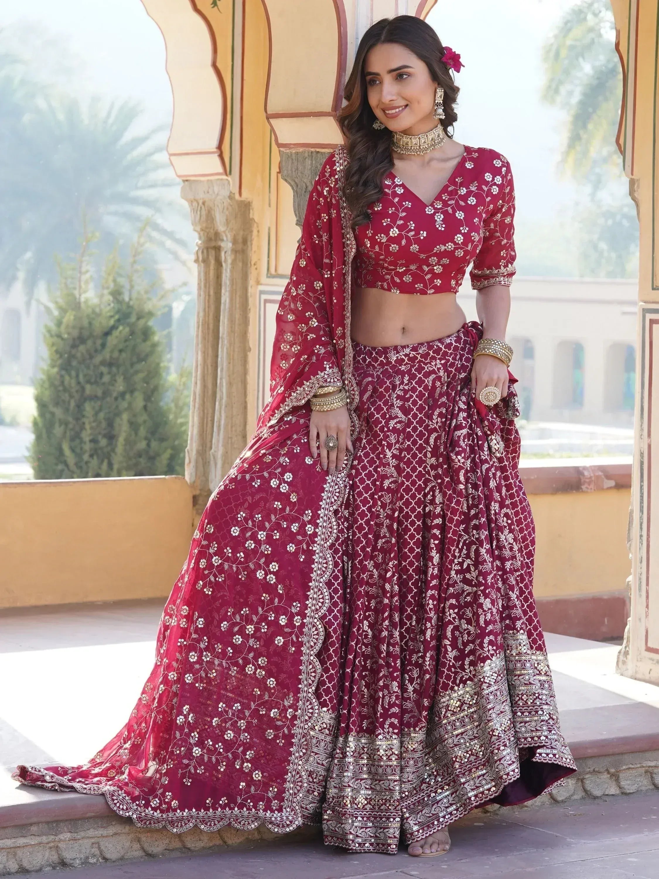 Maroon embroidered lehenga choli with gold detailing, perfect for Indian weddings and festive occasions.