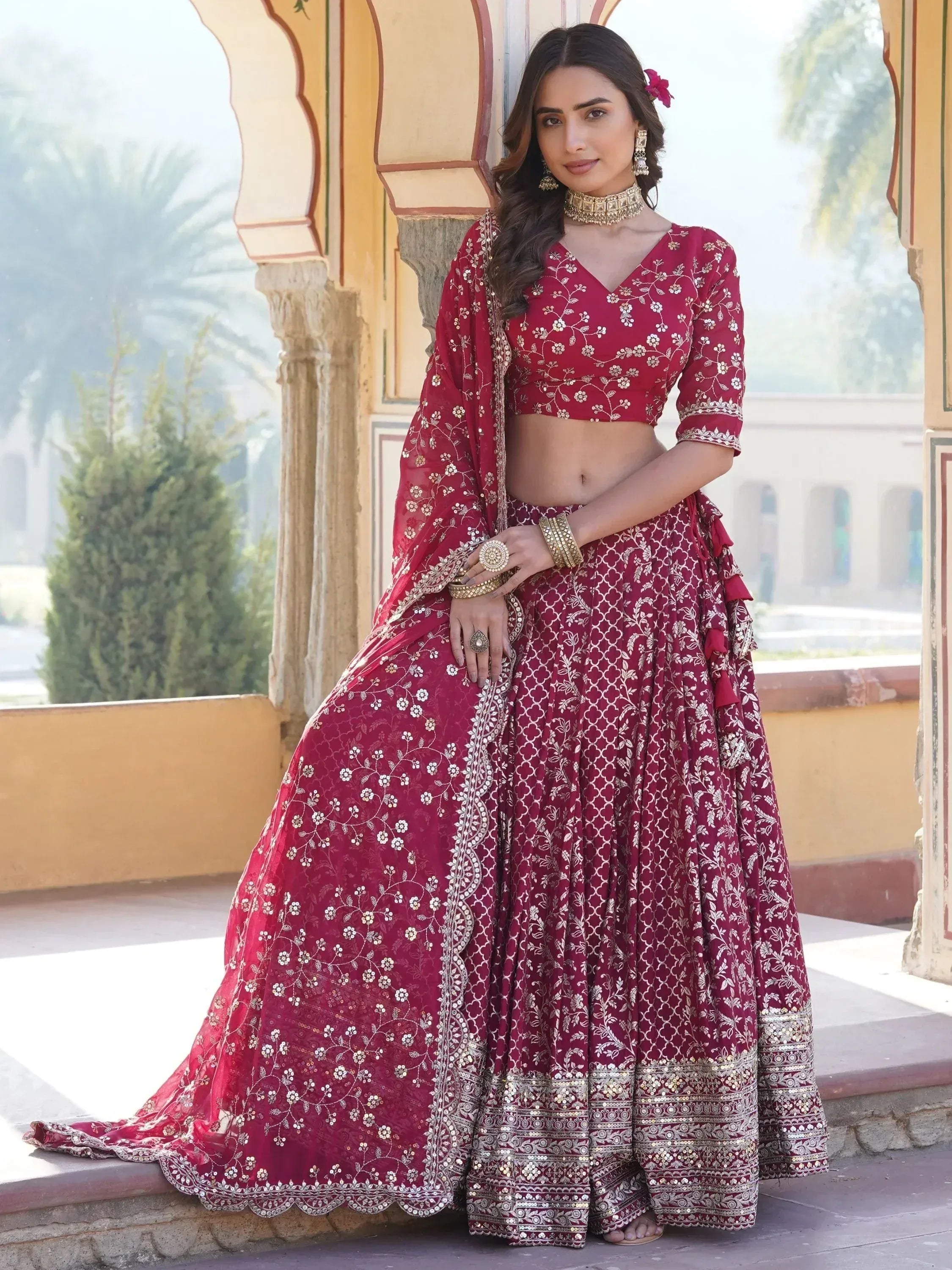 Maroon designer lehenga choli with gold embroidery, perfect for Indian weddings and festive occasions.