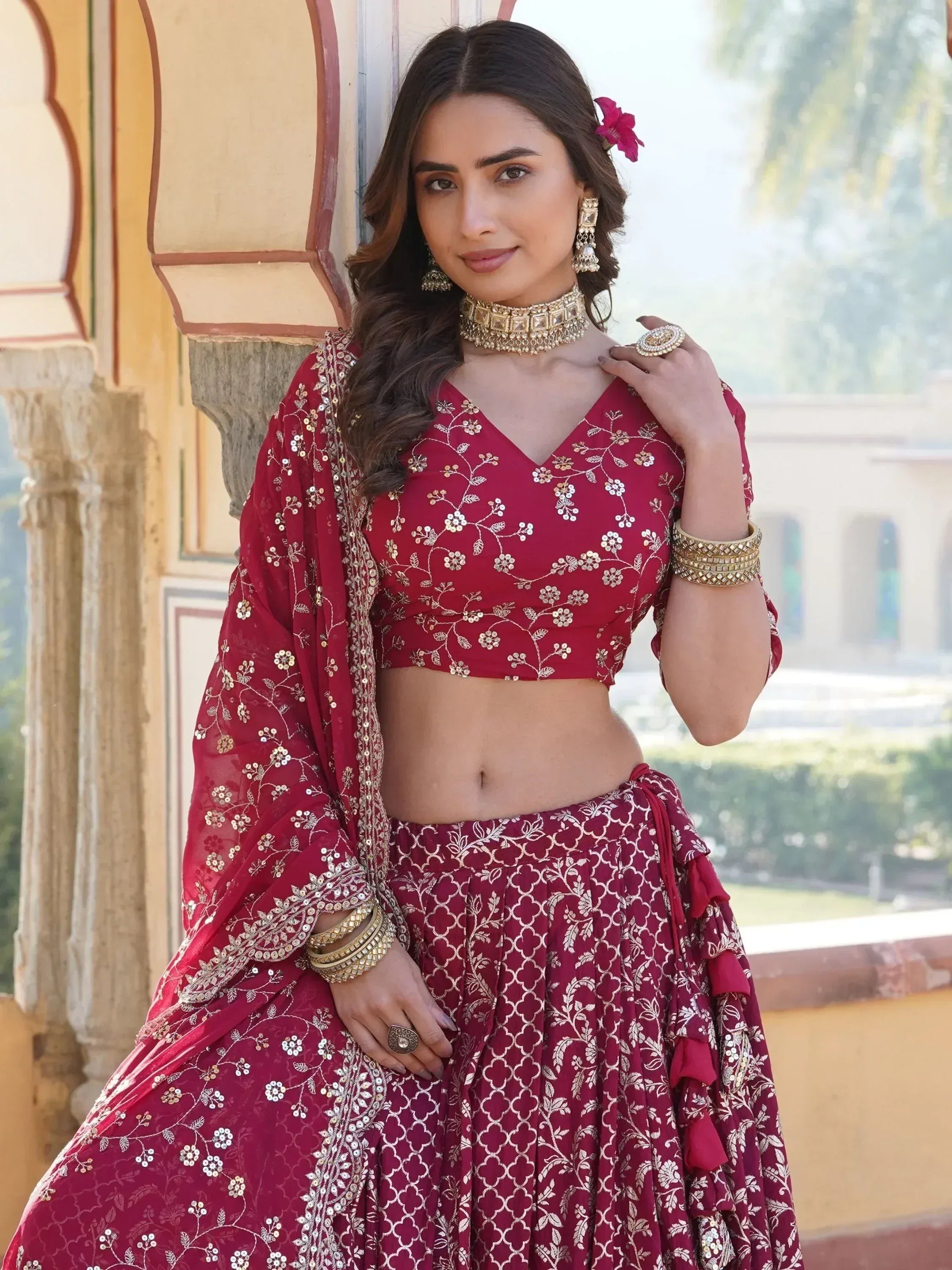 Maroon designer lehenga choli with gold floral embroidery, perfect for Indian weddings and festive occasions.