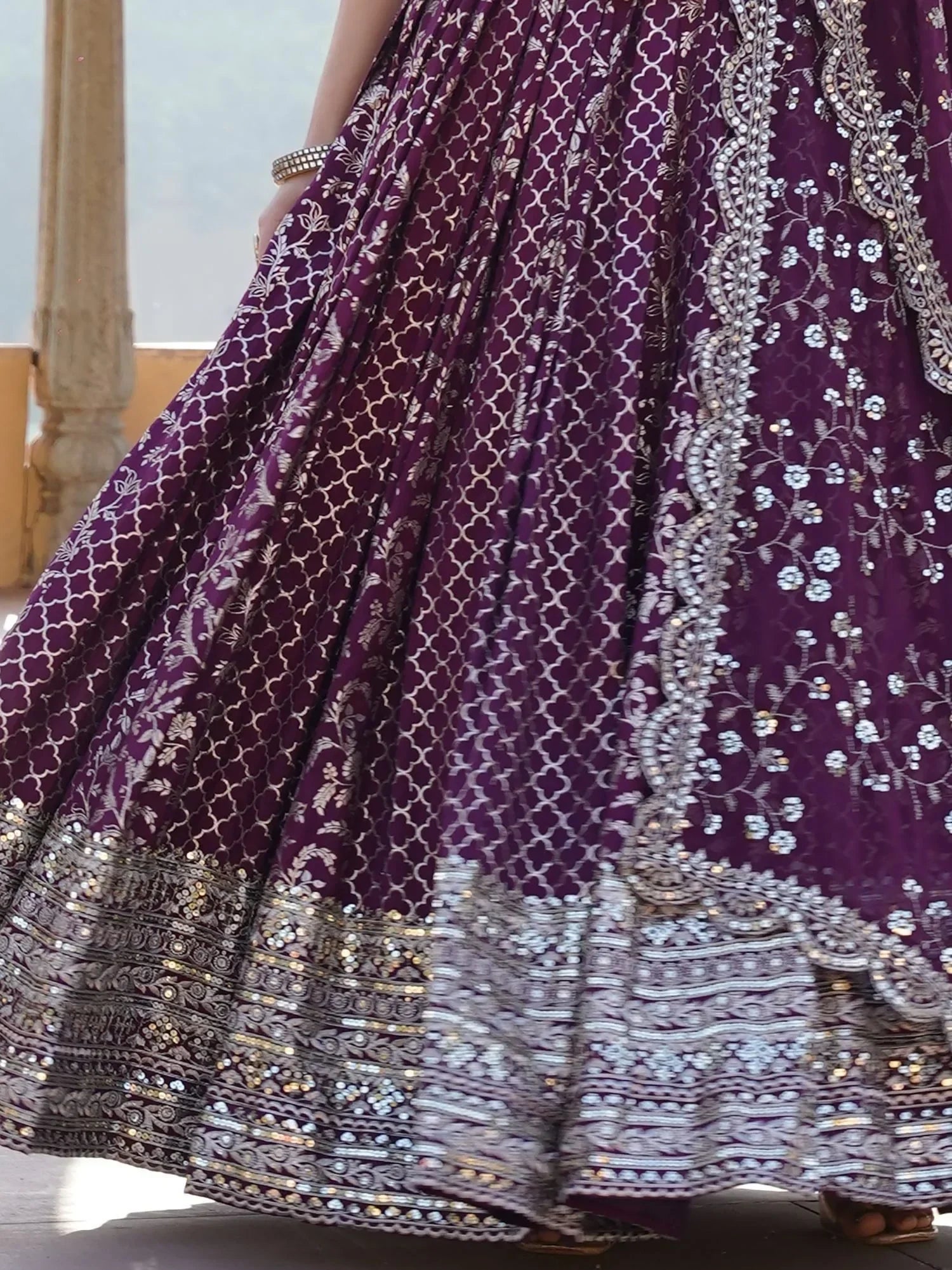 Purple designer lehenga with intricate silver embroidery and sequin work, perfect for Indian ethnic wear.