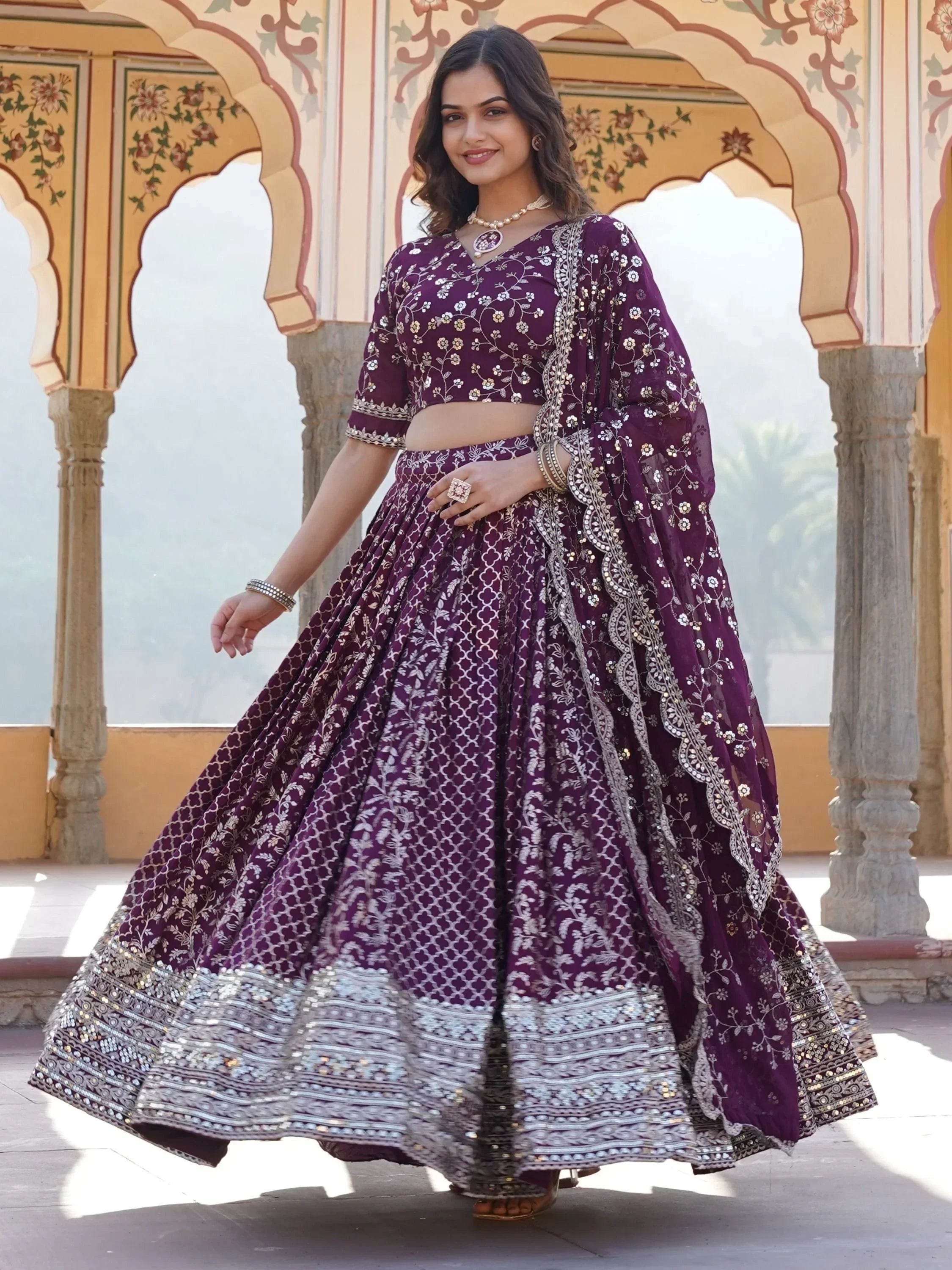 Elegant purple embroidered lehenga choli with floral motifs, perfect for Indian ethnic wear occasions