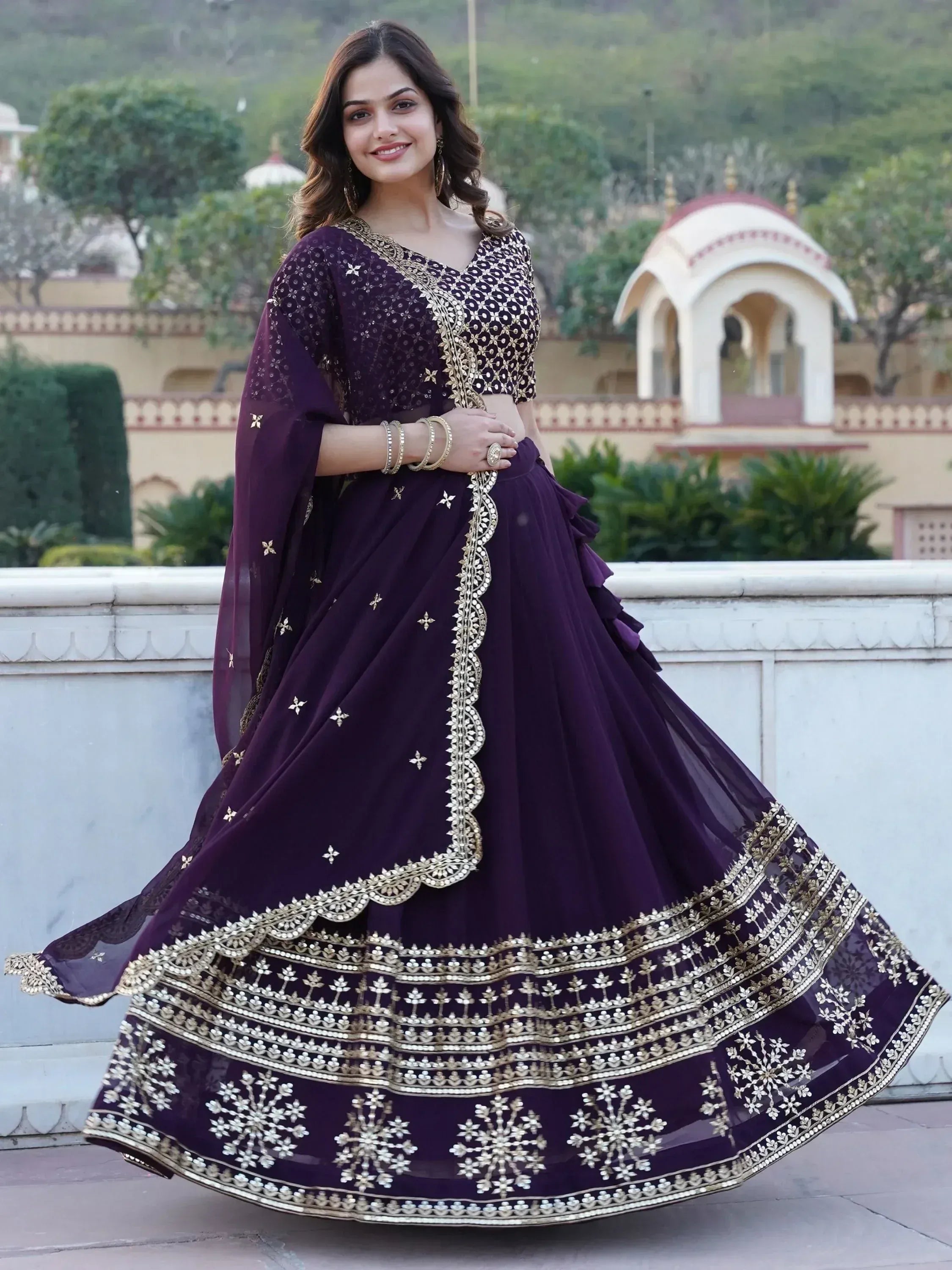 Purple designer lehenga choli with gold embroidery, perfect for Indian weddings and festive occasions.