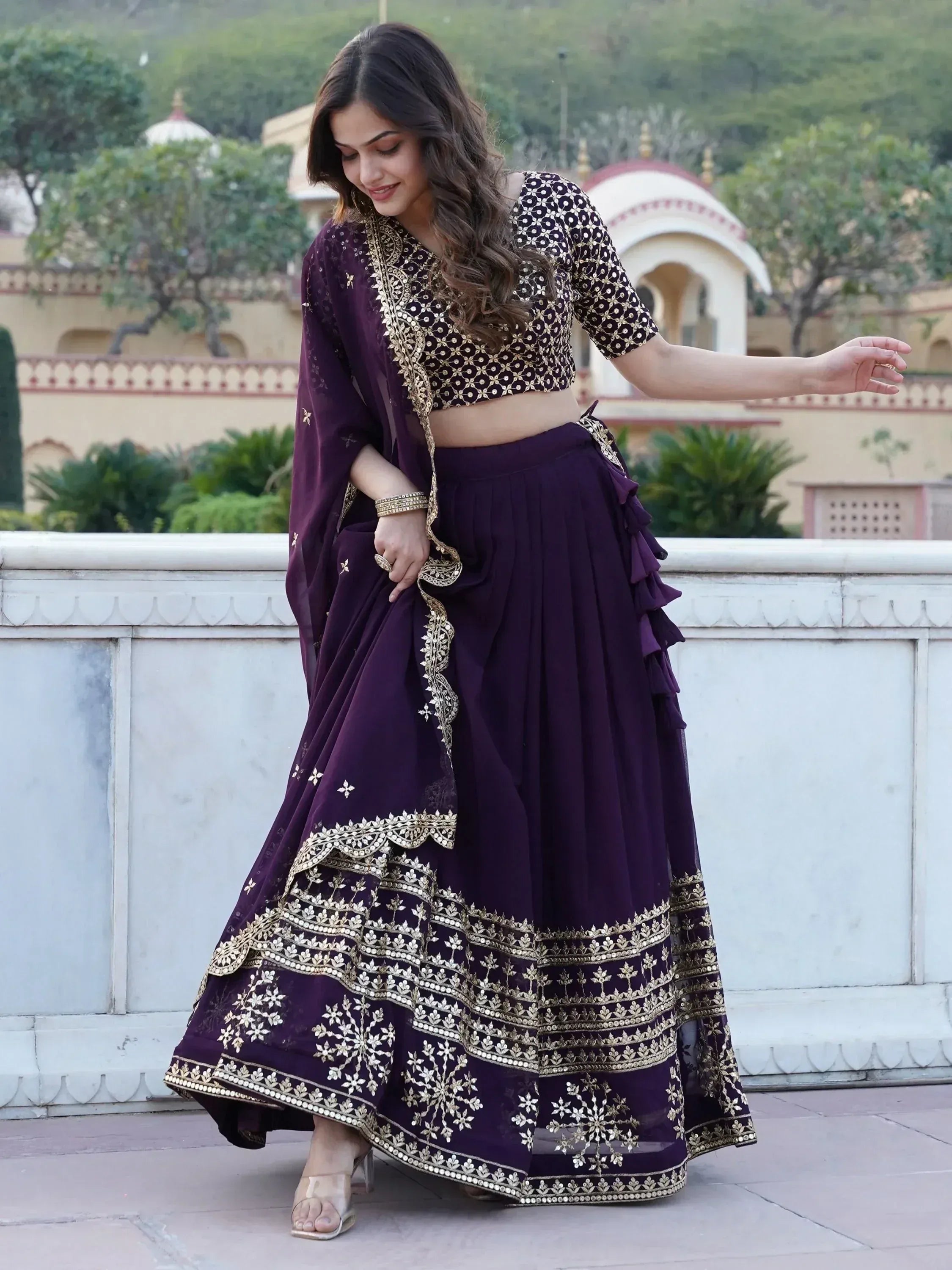 Elegant purple lehenga choli with gold embroidery, perfect for Indian ethnic wear and festive occasions.