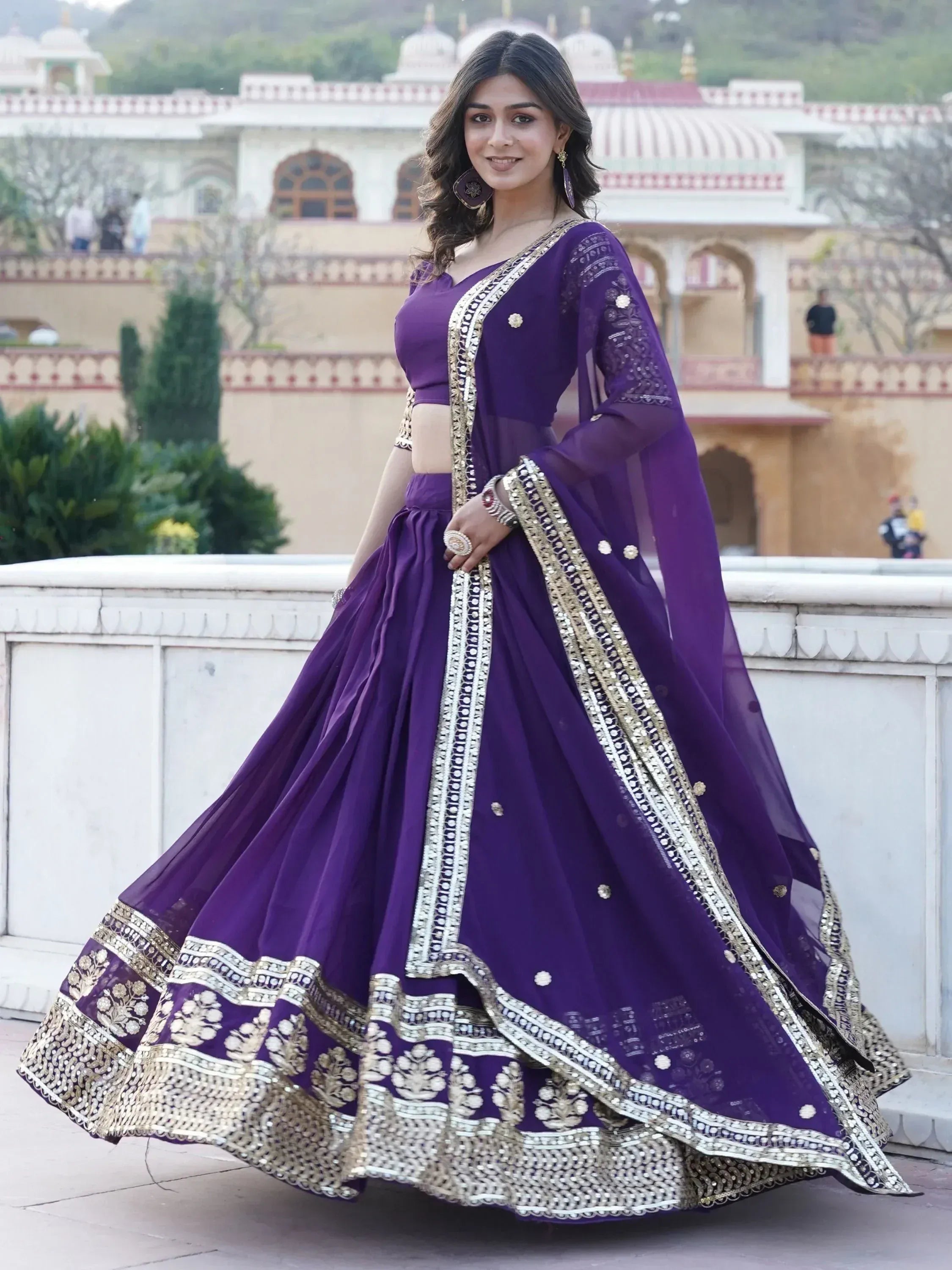 Purple designer lehenga choli with gold embroidery, perfect for Indian weddings and festive occasions