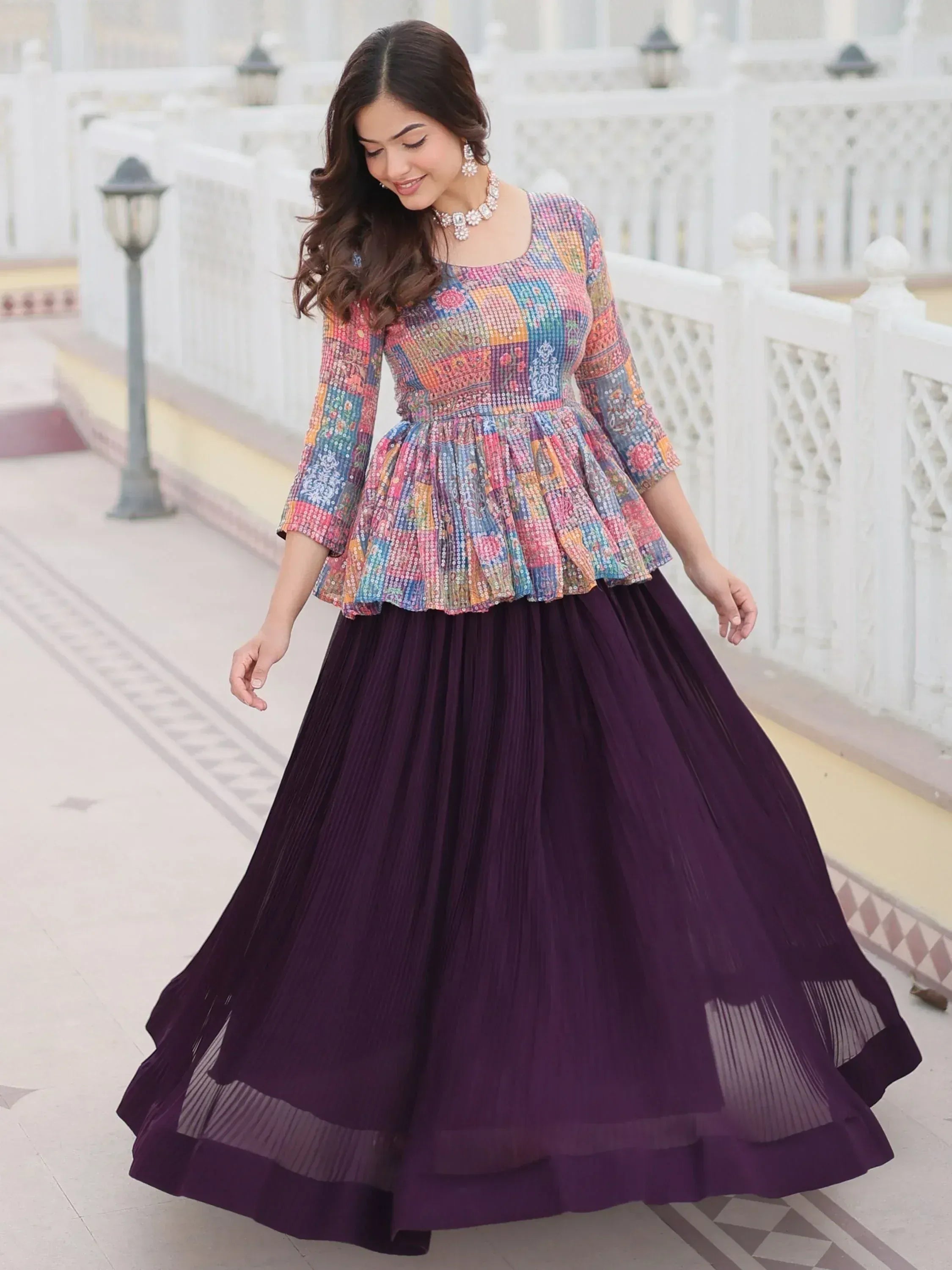 Woman in colorful patchwork peplum top with purple pleated skirt, Indian ethnic wear