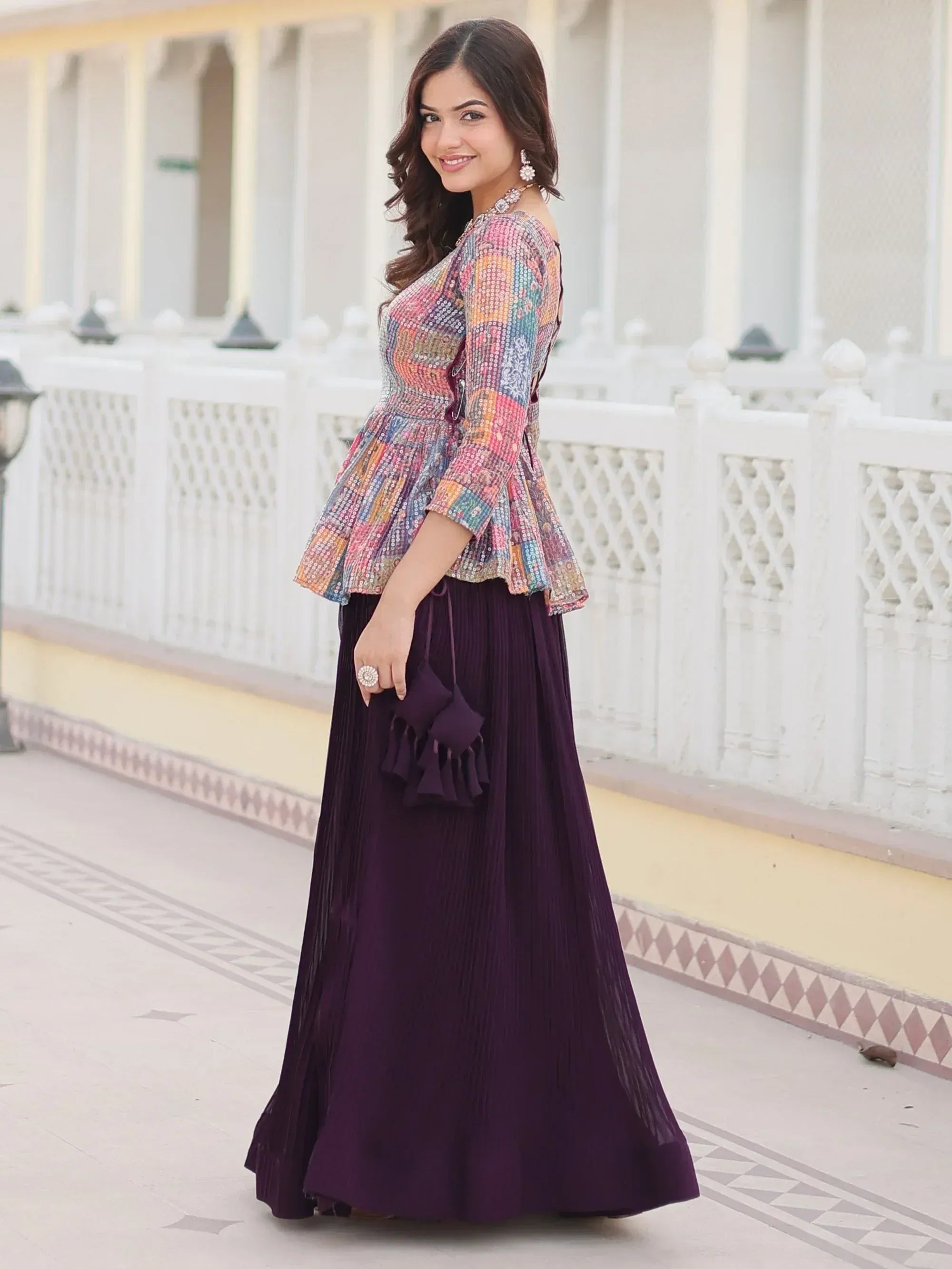 Woman in colorful embroidered top and purple pleated skirt, Indian ethnic wear