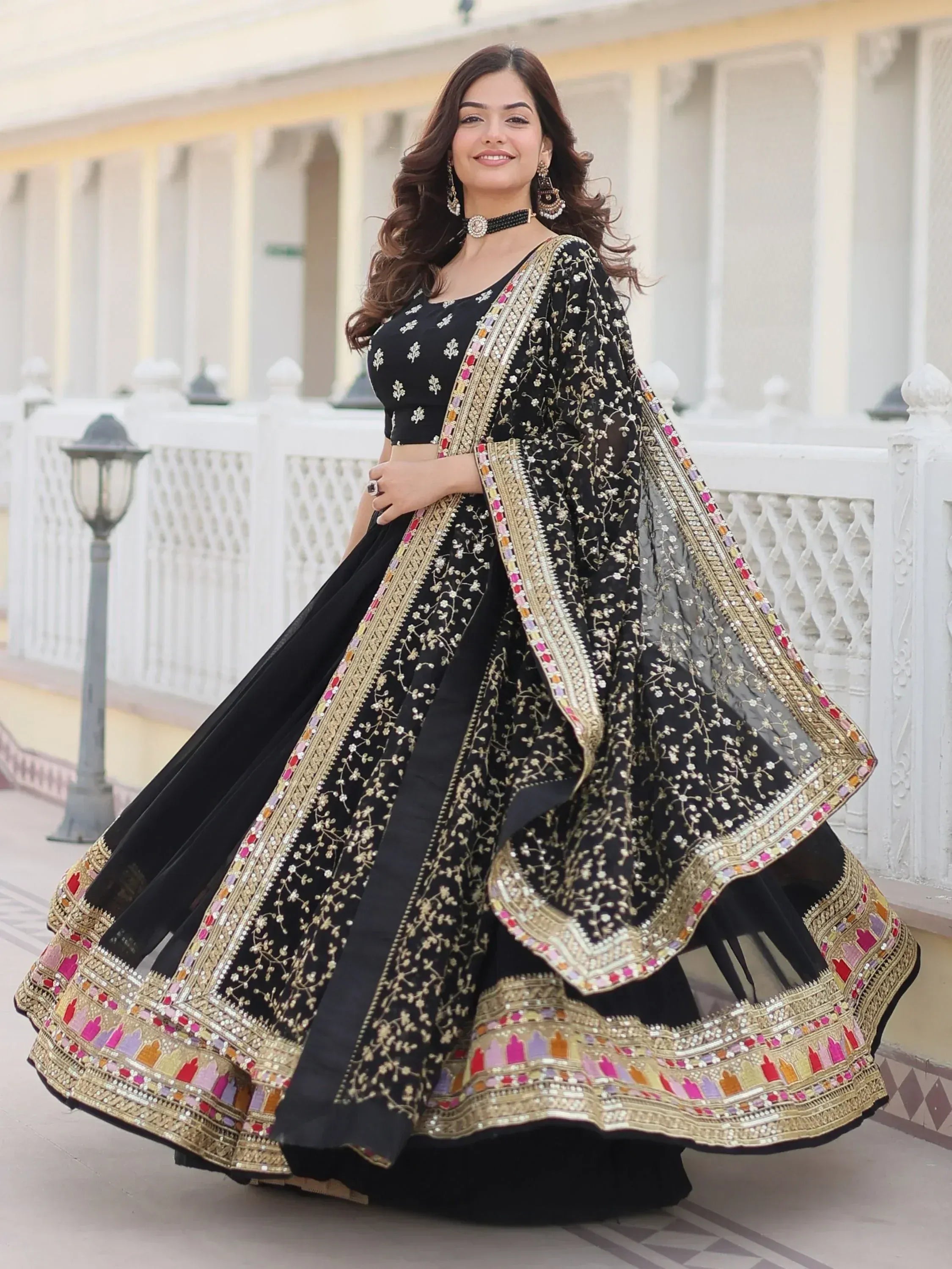 Black embroidered lehenga choli with gold and colorful border, perfect for Indian ethnic wear occasions