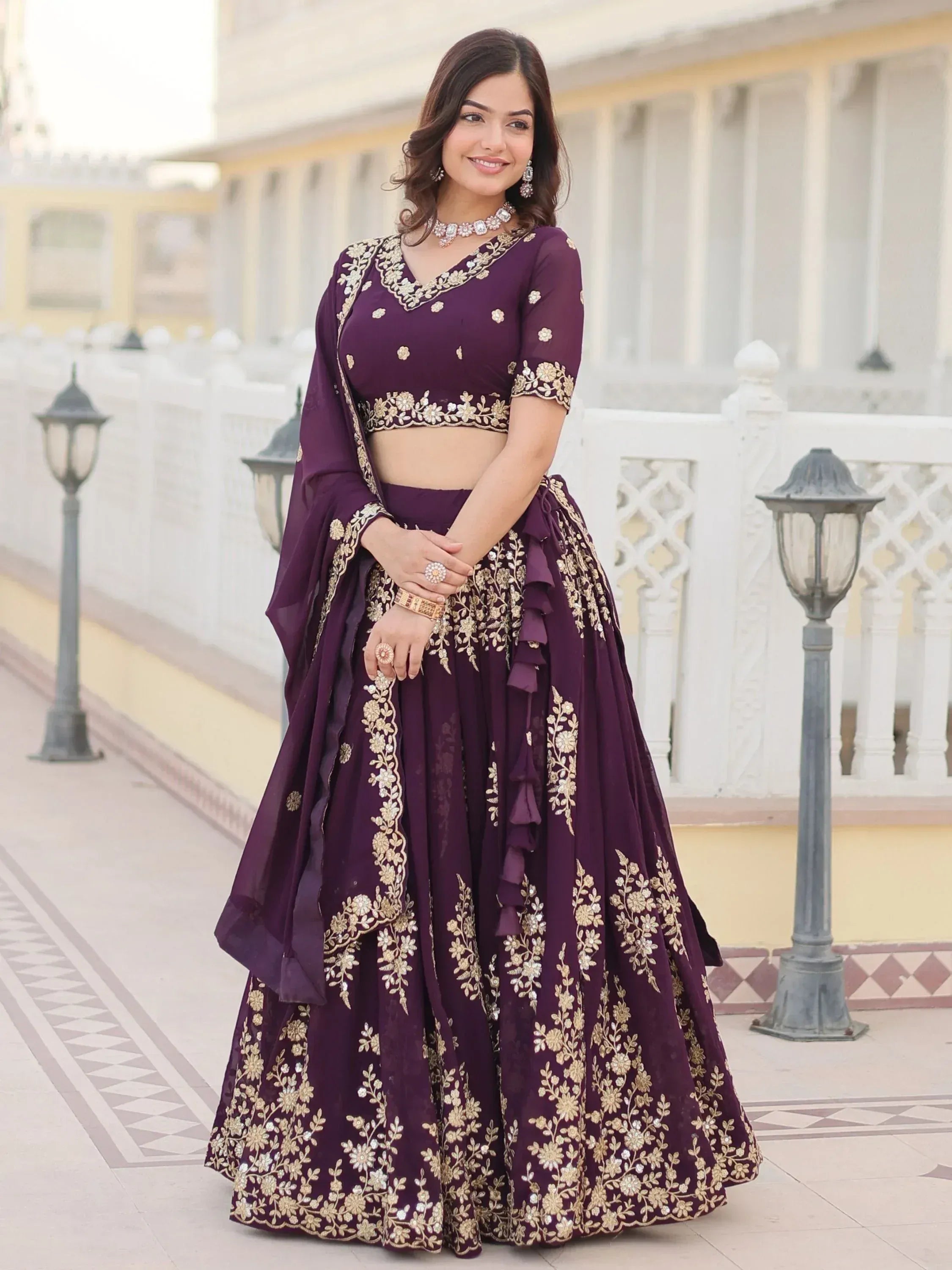 Elegant purple lehenga choli with gold floral embroidery, perfect for Indian weddings and festive occasions.